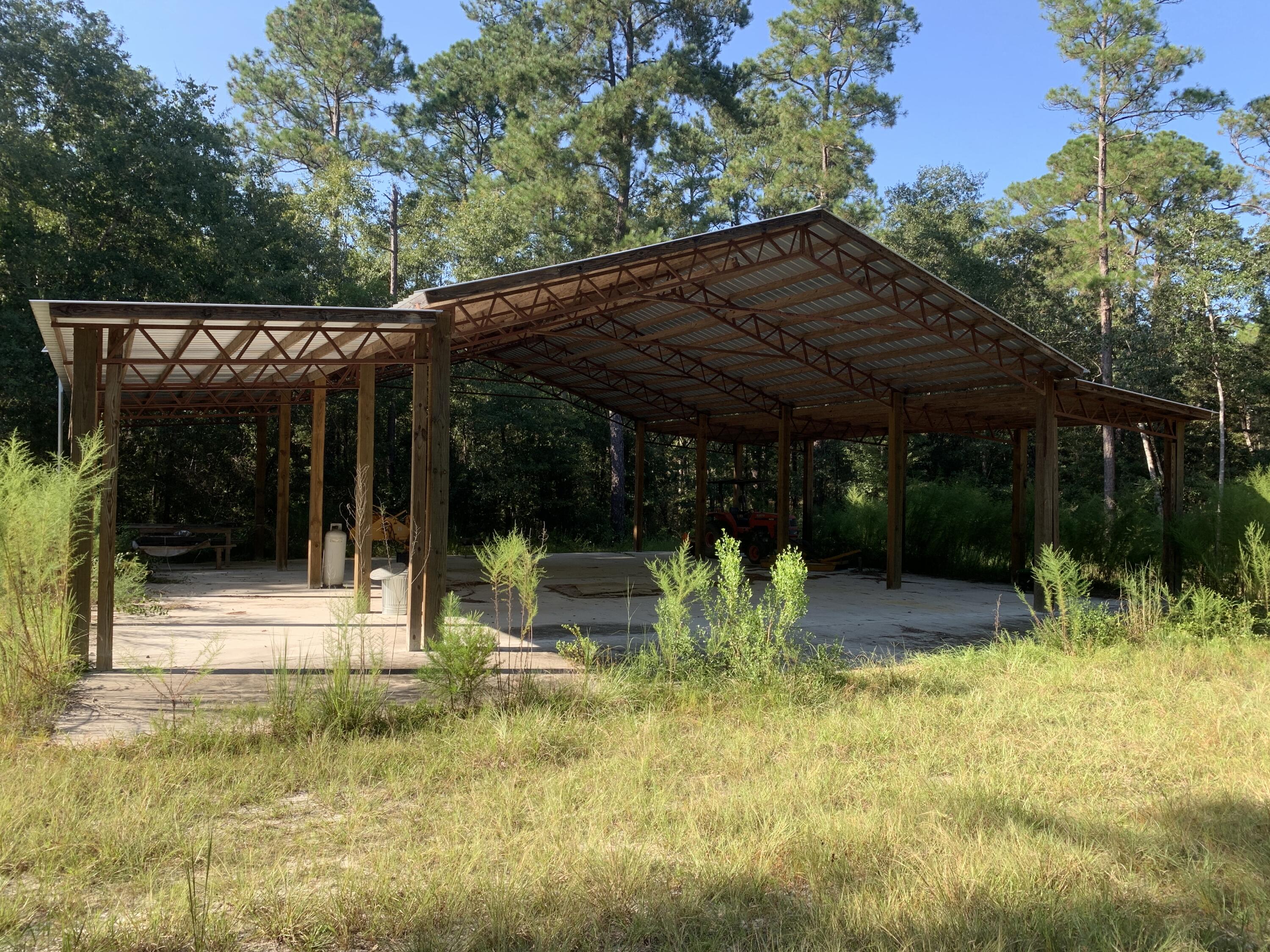 25 Acres inside the secured and gated prestige community of Walton Plantation with a creek running through the property! This parcel features a new very large open barn with concrete slab, several hunting plots and shooting house/ deer stands, and a camp area with shipping container style cabin. there is an on site well installed.  
This community of Walton Plantation does have some common elements shared including a shooting range and open air chapel.  see ALL of the photos.