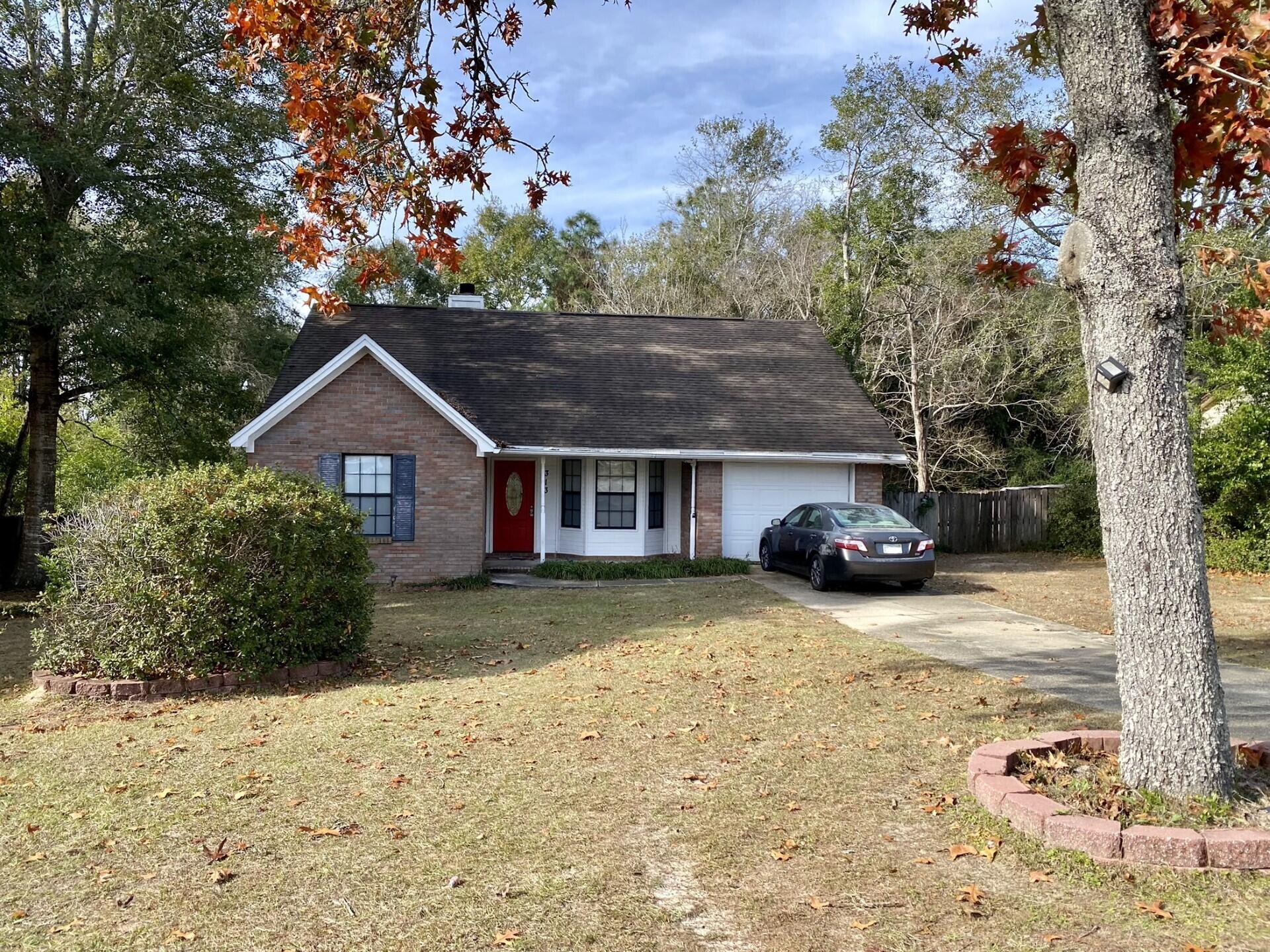 Charming 3bed, 2bath house on a great sized lot in south Crestview plus it's located in the county so you can take advantage of lower property taxes!! In close proximity to Military bases, shopping and restaurants. A lot of updates already have been started - tile throughout, updated kitchen cabinets and quartz countertops, new light fixtures, new doors and more! The living room features high ceilings, fireplace, and sliding glass door that leads to a large Florida room! What a great opportunity for TLC to make this house your home.