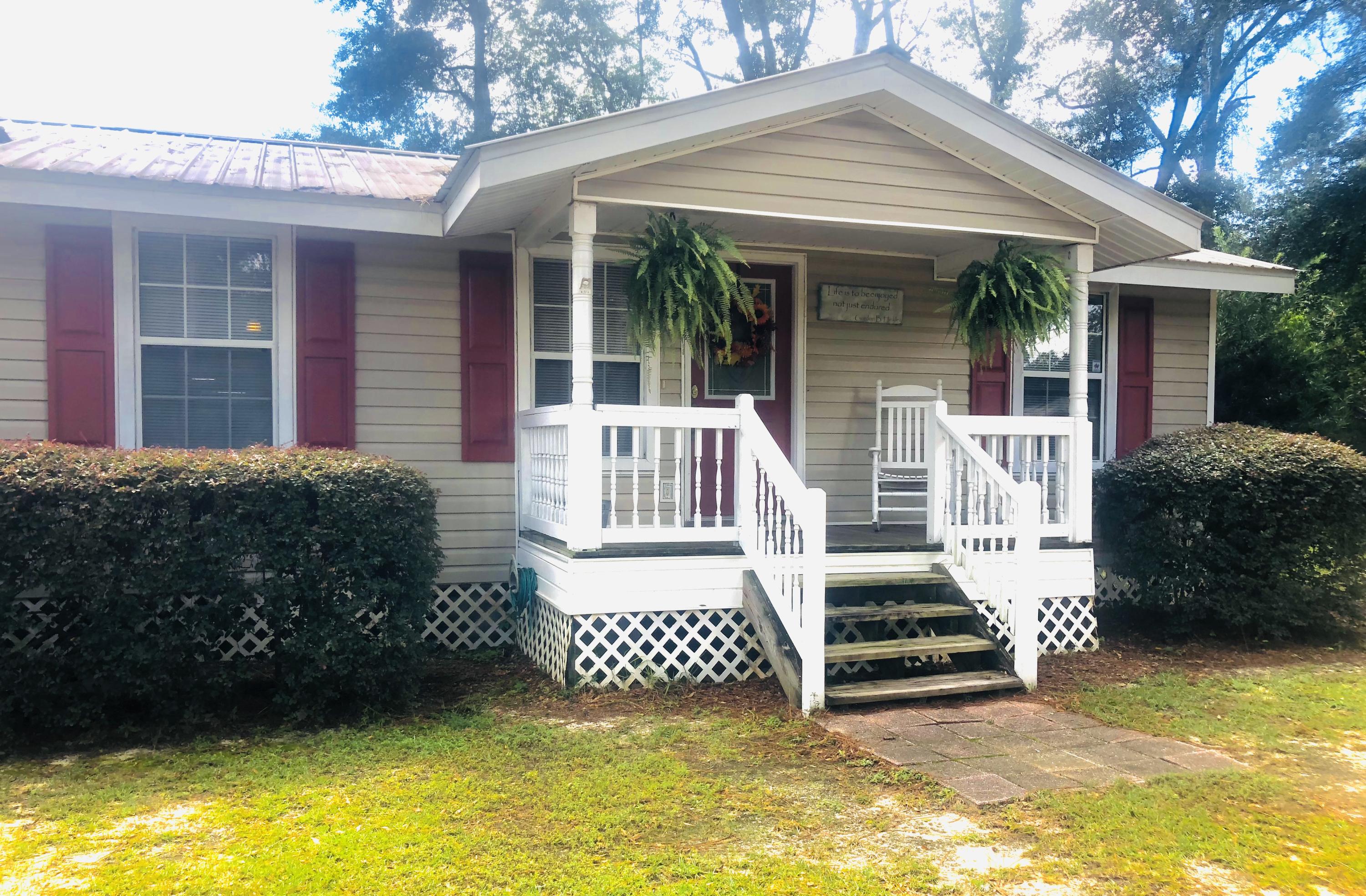 Cozy 3 bedroom, 2 bathroom custom built home located conveniently to everything that DeFuniak Springs has to offer! This home has had several upgrades including laminate flooring in the living room, dining area, hallway and 2 guest bedrooms, hardwood flooring in the master bedroom and tile in the bathrooms. The kitchen features stainless steel appliances, plenty of cabinets and countertop space. Both front and back porches are covered. There is not any wasted space in this home! Easy maintenance due to the vinyl siding, soffit, fascia and metal roof. Please note, this is NOT a manufactured home! There are very few financeable homes in this price range. Don't miss out on this great opportunity!