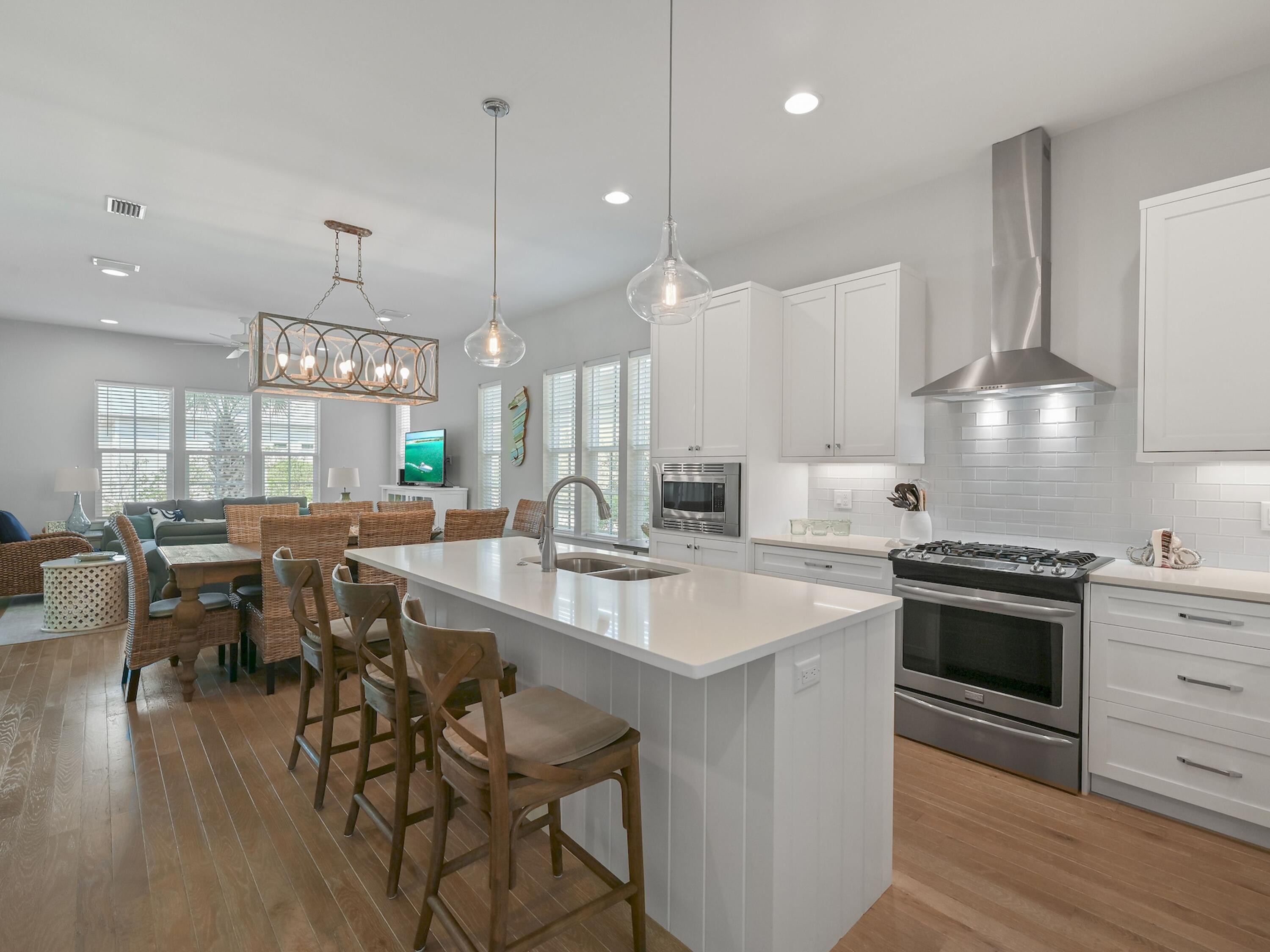Tucked away in the gated community of Cypress Dunes on 30A, this spacious home comes with enviable onsite amenities. A brick-paved driveway leads to an attached garage for your golf cart, beach chairs and a covered entrance. Built in 2017 by renowned John Willis Homes, this well-appointed home has a metal roof, tankless water heater and separate air conditioning on each floor. It strays from the original plan with an additional fifth bedroom/bunk room to accommodate young guests. Hardwood flooring flows through the sitting area to a formal dining area beneath a contemporary chandelier. The open-concept kitchen revolves around a large island with bar seating for three. Crisp white cabinetry, quartz countertops and stainless appliances are complemented by a separate laundry room. There's also a master bedroom with an ensuite on this level. Head outdoors to the screened porch, which offers a quiet escape for socializing or sipping long cool drinks before dinner. An additional open deck is the perfect place to hang out for barbecues and alfresco dining. Wood-tread stairs lead up to three bedrooms (all with bathroom access) and a built-in bunk room for four. The home is ideal as a primary or second home and has a solid history of vacation rentals (six nights minimum). Look forward to fun-filled days on the tennis courts, working out in the fitness room or strolling along the boardwalk to nature ponds. The community infinity-edge pool overlooks the Gulf of Mexico and Topsail Hill State Park with its sail-like dunes and white sandy beach. Hiking, birdwatching and kayaking are available in the pine forest, lakes and wetlands nearby. Golfers are just minutes from four championship golf courses at Sandestin Golf and Beach Resort. Baytowne Wharf and Grand Boulevard provide a host of shopping and dining opportunities from Publix to Emeril's Coastal.