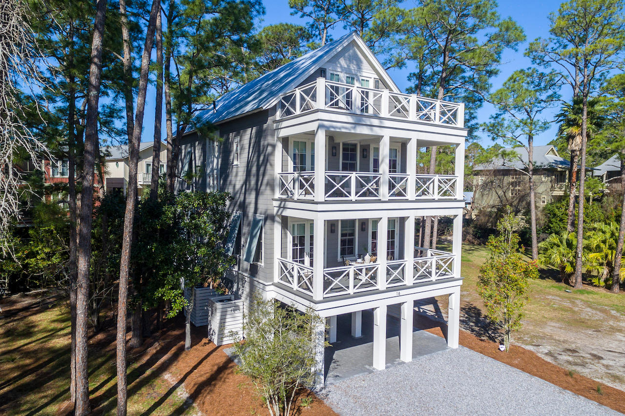 MODEL HOME ON PARCEL 3 IS PICTURED. THIS IS A ''TO BE BUILT'' OPPORTUNITY. This 5 bedroom, 5-1/2 bath fully furnished custom built home is a family or investors dream. This exquisite Magnolia Floor Plan custom built by local builder Luke & Blue boasts almost 3600 SqFt of living space and spectacular views of one of the most beautiful coastal dune lakes. Each floor of this home provides impressive views of Western Lake all while overlooking the community swimming pool area. Open concept living is truly represented in this home. Behold the lake views as you enter the 2nd floor into the inviting custom built kitchen. The solid wood cabinetry with dovetail joinery and cushioned close hardware, marble countertops, Wolf 36'' 6 burner all gas range and
Sub-Zero 36'' built-in refrigerator are some of the features of the kitchen. The hospitable open living allows for dining and entertaining indoors and al fresco on one of the two covered porches. The master suite completes the 2nd floor living area with a custom built walk-in closet. The en suite bath showcases multiple shower heads, dual vanity sinks with quartz countertops and a freestanding bathtub. Take the stairs or better yet, ride the elevator to the 3rd floor! This floor has an additional three bedrooms and laundry. The two western facing bedrooms also have en suite baths with custom cabinetry and quartz countertops. One of the bedrooms has a walk-in closet while the other has 2 separate closets allowing for additional storage space. Facing the waters of Western Lake is the 2nd master bedroom. Instant relaxation is the feel of this master bedroom. Views of the lake can be enjoyed while relaxing in your chamber or step outside onto the covered porch enjoying a glass of wine to end the day. The en suite bath is not to be missed in this gorgeous master suite. Custom cabinetry, multiple shower heads, double vanity sinks and more details that highlight luxury. The 4th floor is an absolute treat to those who enjoy natural light. This final level has a custom built bunkroom with FOUR closets with a balcony allowing for natural light to encompass the room. Grab a cold drink at the wet bar on the way to the loft area of this floor to enjoy the beauty of coastal Florida living. The open porch with Trex decking ensures many years

Community features include: private gated community with 6 exclusive residences situated on 1.5 acres on Western Lake, community swimming pool fronting Western Lake with sundeck, outdoor kitchen, grill & bathrooms, private access to Western Lake including; boat dock with 6 slips (each owner has an assigned slip) & boat ramp, approximately 175 linear feet of frontage on Western Lake & a 5-minute walk to the white sand beaches of the Gulf of Mexico.