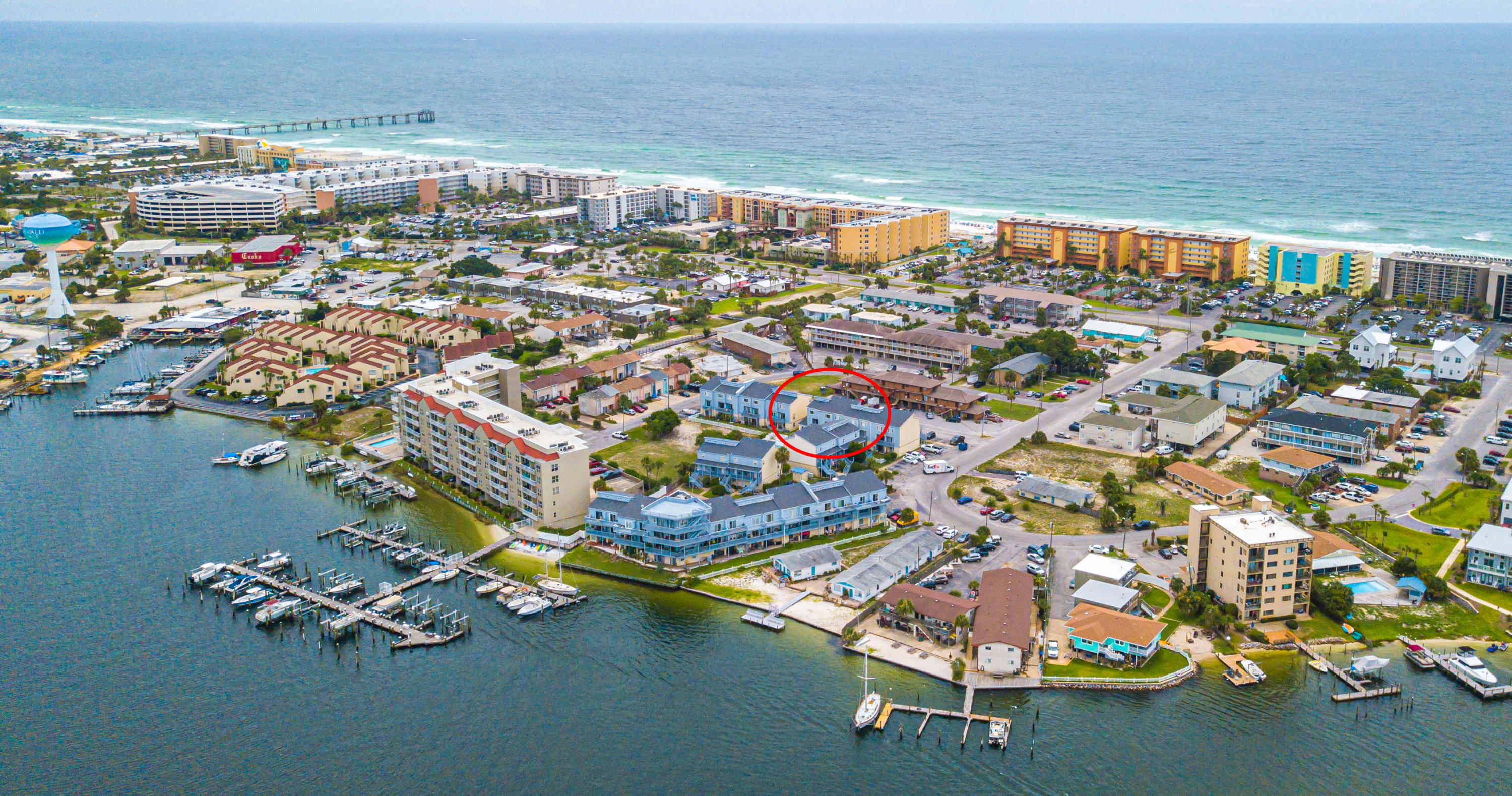 Amazing location on Okaloosa Island! The Commodore's Landing condominium complex sits directly on the beautiful waters of Santa Rosa Sound which features a community dock, pool with large sun deck & green-space. The Gulf is easily accessible across Santa Rosa Blvd, making this place directly between two of the most beautiful waterways in the area! It is not often you get this much square footage for this price on the Island! The unit is fresh, clean and ready for you to call home! Located on the 2nd floor and boasting 3 stories. A large front balcony leading to the front door opens up to the hall way, with laundry, pantry and newer A/C unit. The kitchen is off to the left and has been opened up/expanded, a roomy half bath to the right, opening up to the living area with balcony overlooking the gorgeous blue pool. There is a cubby under the stairs and it makes for great space to store your home entertainment items out of the way, storage etc. There is a small closet that was being used as a tiny office off to the far right. Travertine flooring in the main area, carpeted stairs and fresh engineered flooring on the 2nd level leads to the large bedrooms having vaulted ceilings & private full bathrooms. Ample storage space throughout! The bonus of this unit is that the 3rd floor loft has a real wooden stairwell with a separated door and landing areas. The loft stairs are finished in raw wood & look great, this also makes it easy to stain to your preference, paint or just enjoy as the current owners have. Very few units in the complex have this finished loft with large stairs, most are accessed by a steep ladder type stair that leaves the stairs/loft exposed to the bedroom, this feature improves privacy and allows better furniture placement in both rooms! Schedule your appointment to see this one today!