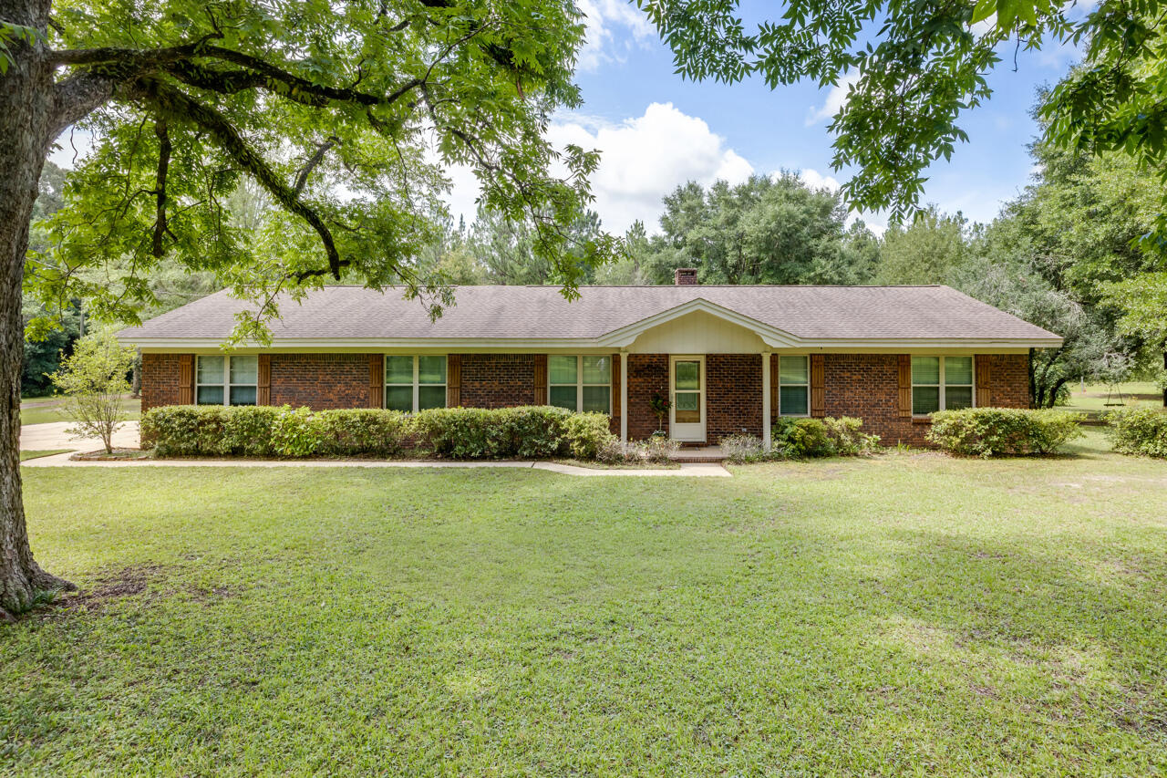 This property offers two parcels with a total of 17.44 acres with a charming country setting. The home on the 3.61 acre parcel has LVP flooring, tile and carpet with an open concept which features a lovely brick fireplace and beautiful kitchen with plenty of counter space.  A nice back porch with fans and speakers, a pole barn, as well as a separate building.  The 13.83 acre parcel has a RV hookup, barn with previous horse stalls with a loft, and a garage with office.  Zoned timber and single-family two parcels being sold as one.  Schedule a showing today!