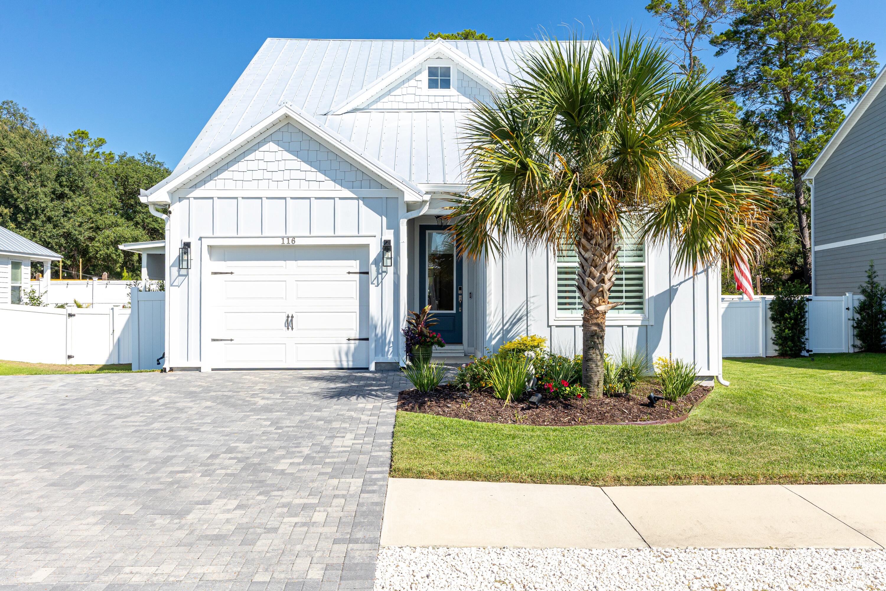 Steps from the Bay, Minutes to the Gulf, Outdoor Living at Its Best

Start your morning sipping coffee as a gentle bay breeze drifts across your shaded patio. This immaculate 3-bedroom, 3-bath home invites you to slow down and savor the coastal lifestyle, whether you're launching a kayak from the community dock, spending the afternoon at the pool, or heading just minutes down the road to the sugar-white sands of the Gulf of Mexico.

Inside, soaring 9-foot ceilings with 8-foot doors create an open, airy feel, while crown molding and plantation shutters add timeless character. The rare first-floor primary suite offers everyday convenience, and upstairs you'll find a second living area, another bedroom with full bath, and a cozy office nook. Storage is never an issue with multiple large closets, and every corner reflects the meticulous care of its current owners.

The home's outdoor living space is a true highlight. Under an extended roofline with a wood-paneled ceiling, recessed lighting, and a ceiling fan, the entire paver-lined patio is shaded and comfortable year-round. Whether you're grilling, dining al fresco, or watching football on the outdoor TV, this inviting space is designed for relaxing and entertaining. The side yard, beautifully landscaped and fully fenced, expands your outdoor enjoyment even further.

Modern comforts include smart home wiring, a one-car garage with EV outlet, and an extra-wide paver driveway for guests. With a community dock and pool just steps away, this home blends convenience, style, and the very best of bay living.