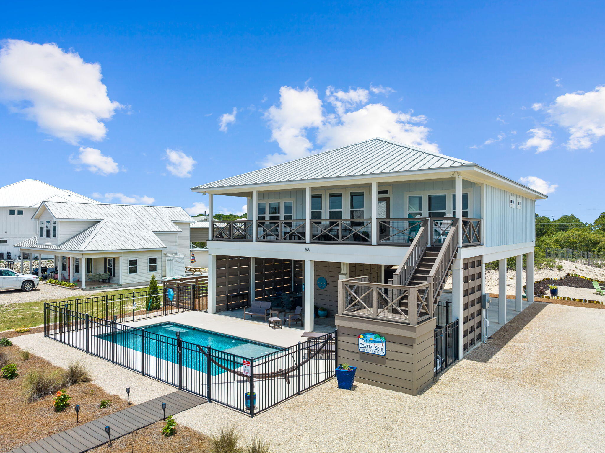 This is a must-see 1st tier house on St. George Island with forever Gulf views and deeded beach access just steps from the heated/chilled pool. Completed in 2019, this like-new 4 bedroom / 4 bathroom beach house has never been rented and includes all the features and luxuries you would want if using it for your personal get away. Those features include propane gas range and tankless water heater, high end appliances, lush landscaping, Trex decking, outdoor fire pit, pool front entertainment area, and LVT and tile flooring throughout. The beach butler lift makes it easy to stock the house with groceries or bring up luggage. While the house design and finishes are amazing, what makes this house unique is its endless Gulf views and beach access. The ground elevation of the lot is higher than W. Gorrie Drive so that you can easily enjoy Gulf views from the pool deck and under house entertainment area. A Trex covered walkway leads from the pool deck to the deeded beach access just steps across the street. The Gulf views only get better from the living level of the house. The huge 10'x44' covered front deck boast Gulf views you must see to appreciate. The views don't end there. Gulf views can be enjoyed from the living room, kitchen, master bedroom, and secondary master bedroom. There is ample parking, both covered and uncovered, including room for boat trailers and RVs. The house is sold mostly furnished with some exclusions. Cape & Coast Premier Properties projects annual gross rental income of $140,153 if you chose to rent. If you have never visited the laid back beach town of St. George Island it is worth a trip. The island is low density, never crowded, and pristine old Florida. Properties like this rarely come to market on St. George Island, so don't miss your opportunity. Buyer to very all data and dimensions.
