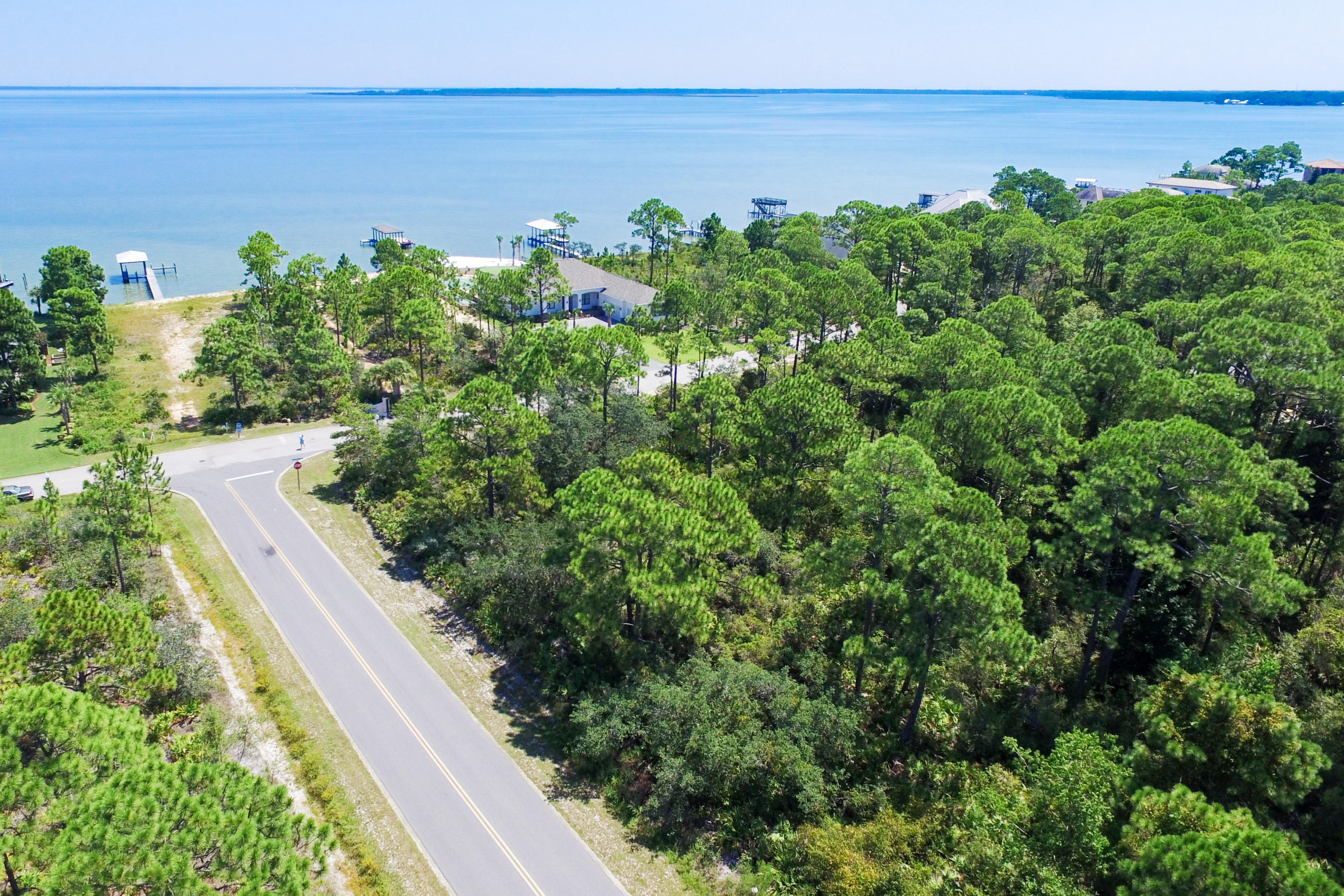 This home site is located directly across the street from bay in the private gated community of Grand Cove at Driftwood Pointe in the neighborhood of Driftwood Estates. Possible bay view from a second story home. There is also a deeded bay access easement conveyed with this lot. Great location!! Close to beaches, the bay, shopping, restaurants, golf courses and much, much more. Don't miss this perfect opportunity to build your dream home on the Emerald Coast.