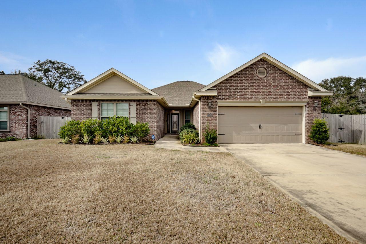 Stunning timeless beauty! This 4 bedroom/ 2 bath home features beautiful dark wood floors complemented by wood cabinetry and granite counters. Open floor plan flows smoothly from the living room to the dining and kitchen. From the moment you walk in, you know this home is quality with the lighted double tray ceilings in the living room, 7 inch crown molding, and oversized baseboards. 42 inch wood cabinets in the kitchen with under cabinet lighting and plenty of counter space will satisfy the pickiest of chefs. The master bedroom is a dream! It also features a tray ceiling with glow lights, a huge walk in closet, and ensuite bath. It also has ''quiet zone'' insulation between the bedroom and living room. Both bathrooms have dual sink vanities. have dual sink granite top vanities. Cont... Master bath adorns a large soaking tub and separate shower. Finally, not to be outdone by the inside, there is a covered lanai overlooks fenced in yard with storage shed. The garage is also immaculate with baseboards and epoxy floor. Technical aspects of the home is prewired for surround sound (living room and lanai), wired security system, Earth Cents Certified with water heater and HVAC heat pumps. Fabric shields for doors and windows provide stress-free protection in case of Hurricanes. Sprinkler system with well pump for cost effective lawn maintenance. AND GUTTERS!  Home is centrally located close to schools, shopping, dining, and the two Air Force Bases (Eglin/Hurlburt). Neighborhood is also adjacent to the city's new Stillwell Park that offers a playground, paved walking trails, and a basketball court. This home leaves nothing to be desired.