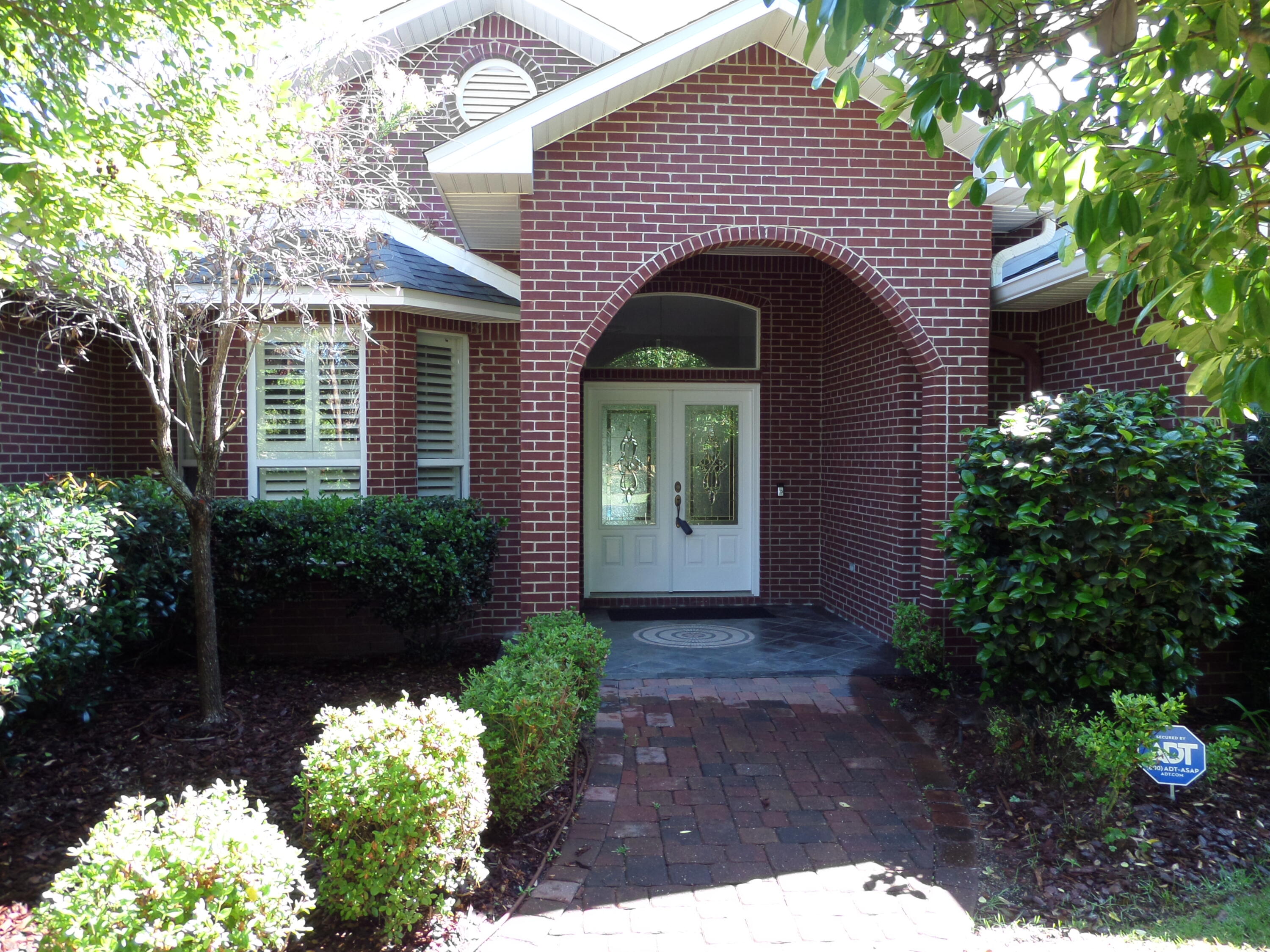 Custom Design Brick Ranch that backs up to the Bluewater Bay (BWB) Golf Course in BWB subdivision.  Open floor plan with multiple doors leading to a large, covered patio, ideal for entertaining with an outdoor granite wet bar. Lushly landscaped with a wrought iron fence.  Lanai with a large inground heated saltwater pool with spa. 4 Bedrooms 3 Baths, large master suite. A new Roof installed in 2025. Home upgraded with many extras.  Formal living/dining room combination with crown molding throughout. Kitchen and baths have granite counters.  Porcelain tile throughout the home. Fireplace in Family room, Cental Security/Sound system.  A highly sought after neighborhood in BWB.  See documents for additional information.