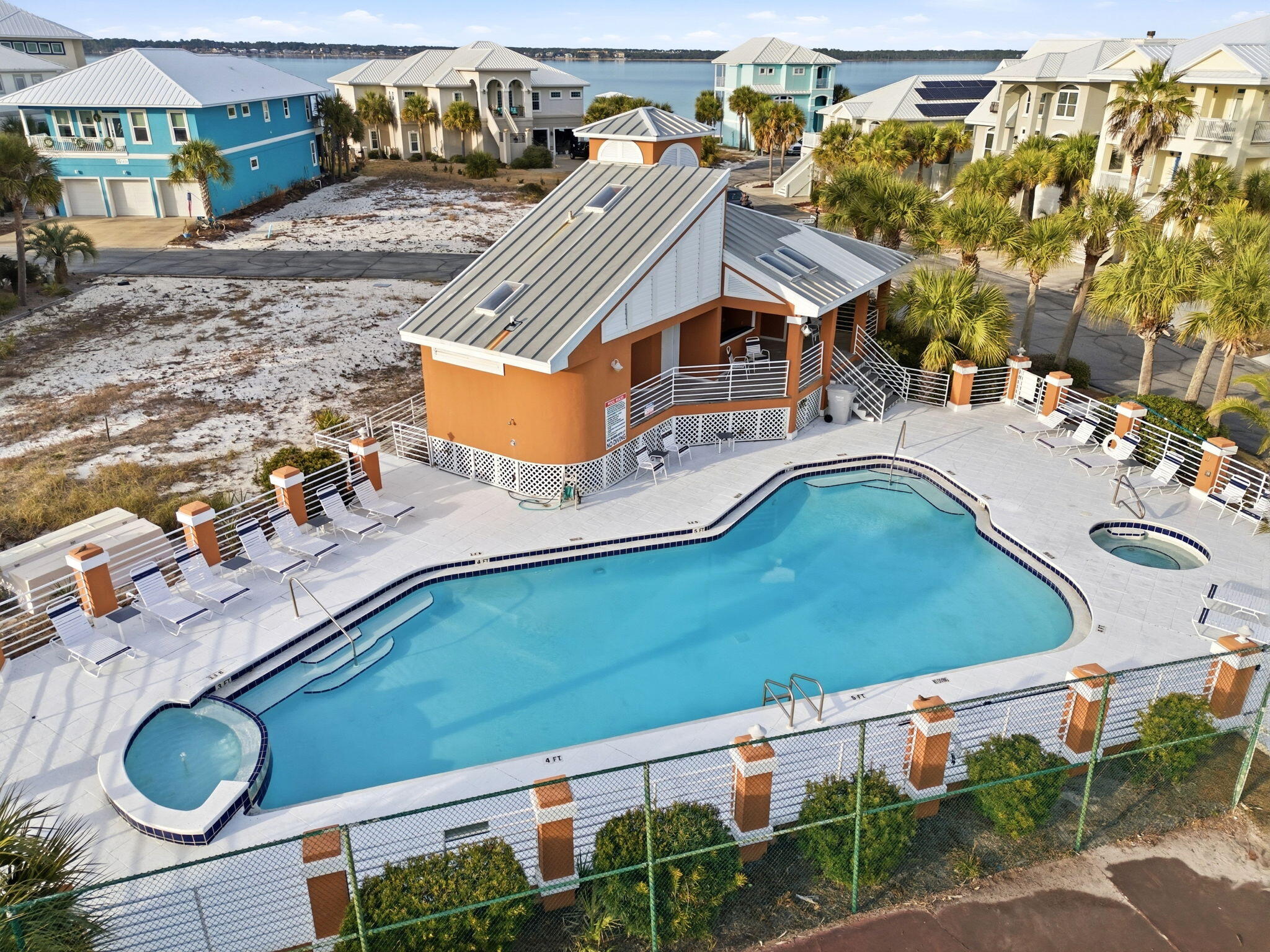 WATERVIEWS and HOUSE PLANS convey with this lot in the highly coveted neighborhood of Caribbean Isles.  This gated community is the ONLY neighborhood on Navarre Beach to offer a swimming pool, hot tub and tennis courts.  Short stroll, bike ride or golf cart ride to the multiple public beach accesses.  The National Seashore offers miles of paved roads to cycle, walk or jog with scenic, pristine views of the Gulf of America and Santa Rosa Sound.  Navarre Beach is home to shops, restaurants, nightlife and fun events such as the Mardi Gras and Christmas Parade. The house plans are stunning with multiple decks to capture the waterviews, 4 bedrooms, 3 ½ baths, a second-floor lounge and a 3-car garage. Caribbean Isles allows for short term rentals so once built; you can easily project $75,000 in rental income.  There are very few available lots on Navarre Beach.  Don't miss one of the rare opportunities left to build your dream home on an island! **Plans will be given to the buyer upon successful closing.