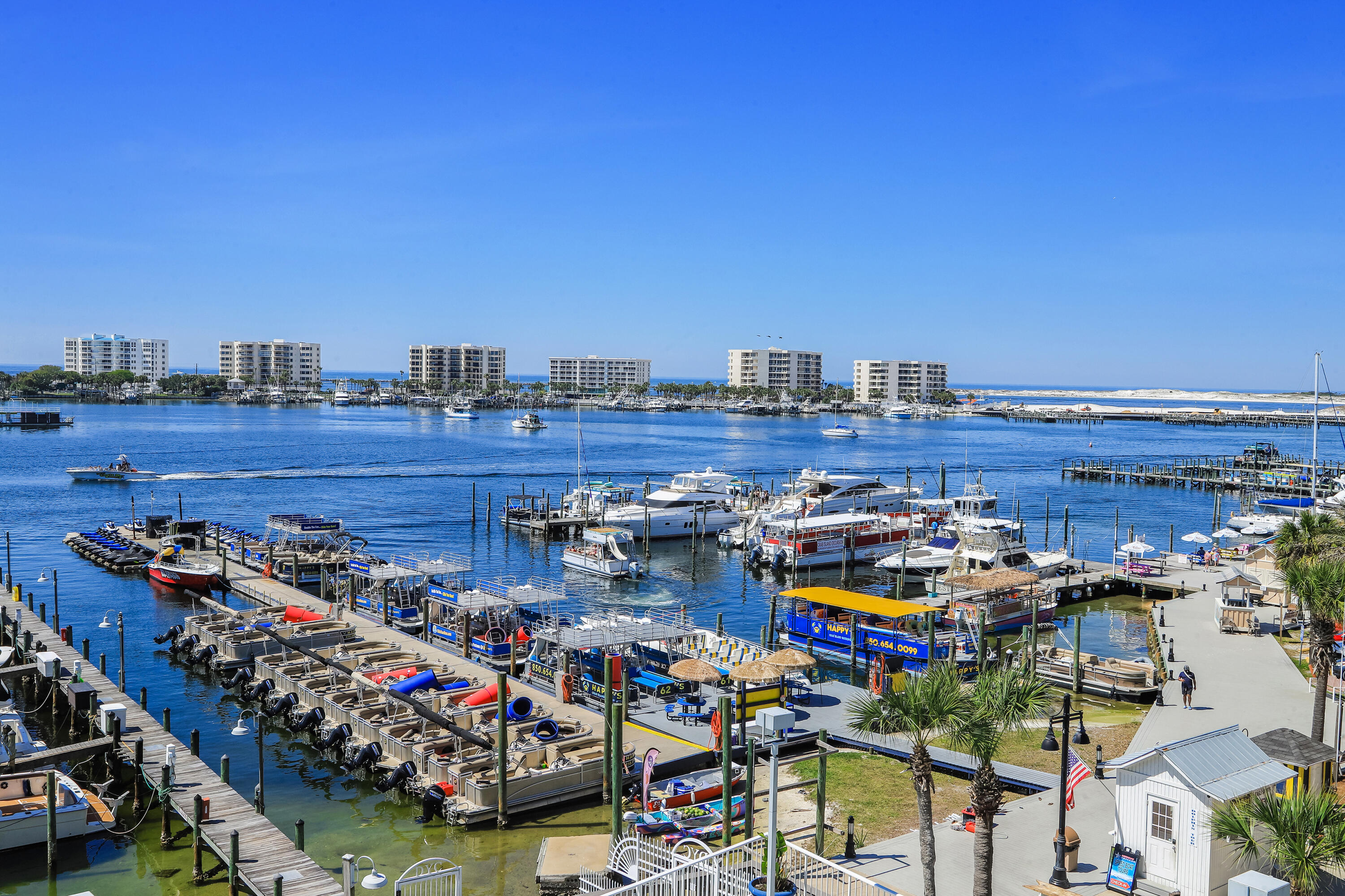 This end unit on the Destin Harbor faces west Destin overlooking the Destin Harbor and the scenery of fishing boats going out and coming in all day long.  Endless view of the harbor from the balcony, living room, kitchen and master bedroom. Also, at night the harbor activities such as fireworks at Emerald Grande, the annual City of Destin 4th of July firework show, boat parade, Blessing of the Fleet, Destin Seafood Festival to name a few can be seen.
The 3 bedrooms and 3 full bathroom unit has been completely renovated as far as opening up and renovating kitchen & bathrooms, added master bedroom walk in closet, new floor throughout, paint, fixtures, and custom window fixtures. Destin Yacht Club has gated & protected access to the building parking lot, lobby, elevators, pool, boat dock. Beautifully renovated lobby with gym and pool table overlooking pool and harbor. On-site association manager, downstairs party room and events. There was a special assesment that is paid for and completed making the building up to par with all engineering regulations. Destin Yacht Club has  with the following improvements... new windows, doors, roof,  new slider doors to balcony in the unit, waterproof balconies and outside of the building. This unit has one of the most beautiful harbor views and every evening the sunsets over the Gulf of Mexico can be seen.  Walk right out the gates of the Destin Yacht club onto the boat docks  to over half a mile of some of the best restaurants and entertainment in Destin.