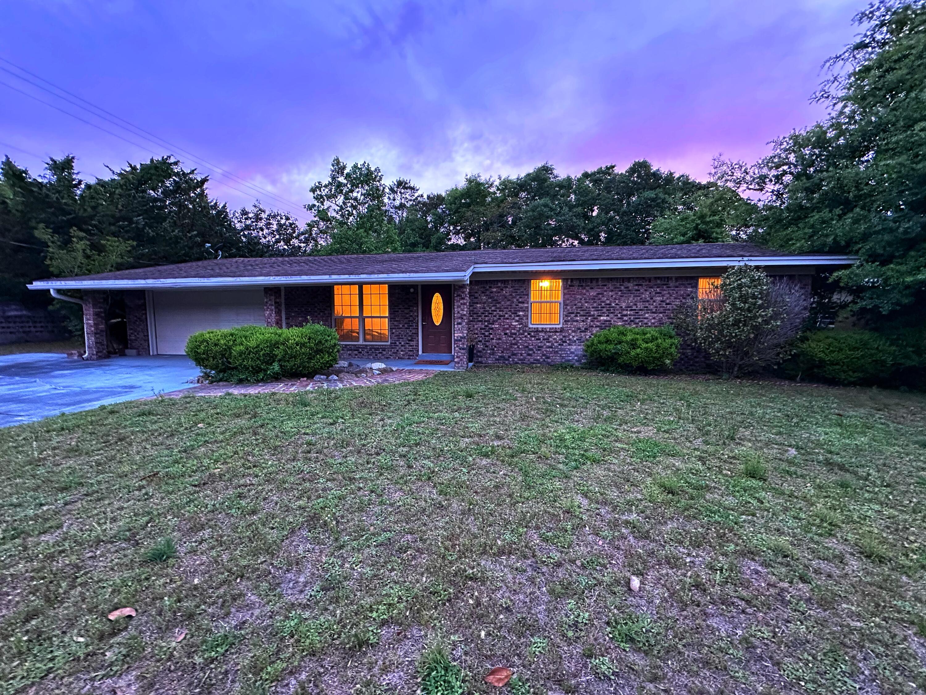 Welcome to this centrally located ranch-style home in Fort Walton Beach — where natural light, a flexible layout, & the ultimate backyard escape come together.

Inside, you'll find two spacious living areas & a centrally placed kitchen that makes everyday living and entertaining feel easy. 

The den or dining space features a stunning floor-to-ceiling gas fireplace feature wall & a sliding glass door that opens right onto the expansive backyard. 

The large, fenced yard offers storage options & plenty of space for parties, water games, or shade on a summer day. 

An extended driveway adds room for vehicles, a boat, or visiting guests. Bonus: No HOA—but there's a well-kept neighborhood park just steps away! 

New roof with accepted offer, move-in ready.