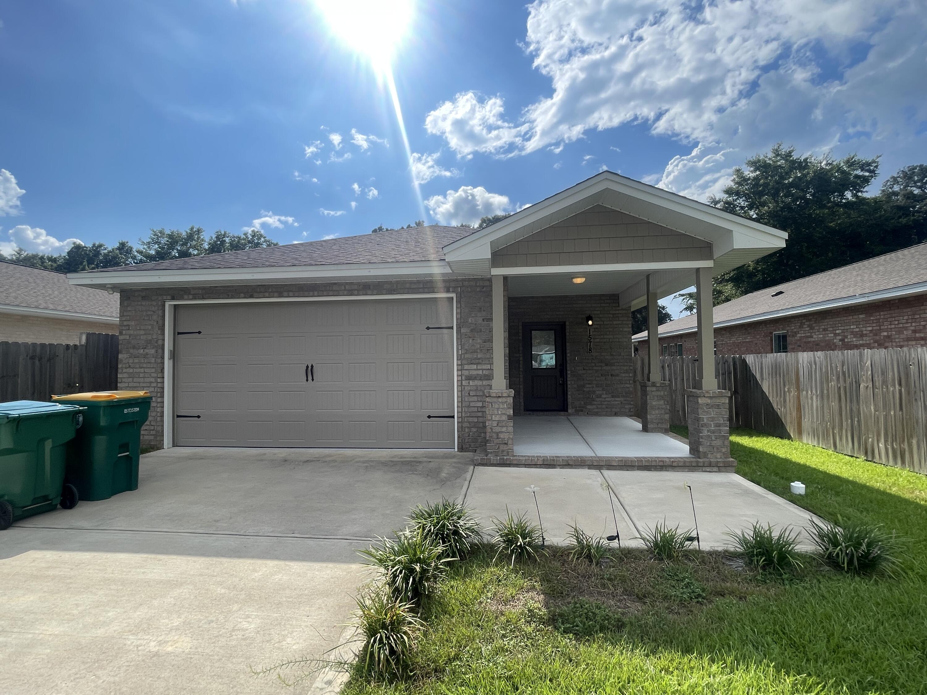 Step into this absolutely stunning 3-bedroom, 2-bathroom home, built in 2021! Enjoy the modern comforts of newer construction paired with an unbeatable location, just minutes from local military bases, within walking distance of the elementary school, and with quick access to the Mid-Bay Bridge for trips to the beach, shopping, dining, and entertainment.

This home immediately impresses with its charming curb appeal, a welcoming covered front porch, and a spacious, privacy-fenced backyard complete with a covered patio—perfect for relaxing or entertaining. The two-car garage offers ample space for parking and storage.

Inside, you'll find a bright and airy open floor plan with recessed lighting, contemporary finishes, and neutral colors throughout. The living area flows seamlessly into the formal dining space and the kitchen, which is outfitted with granite countertops, stainless steel appliances, a large island with a breakfast bar, plenty of cabinetry, and a convenient pantry.

The primary suite, tucked away at the back of the home for added privacy, is generously sized and features an en suite bathroom with dual vanities and a walk-in shower. Two additional bedrooms offer plenty of space and share a full guest bathroom.

Pets may be considered with prior owner approval and a non-refundable pet fee. No smoking permitted, including vaping.