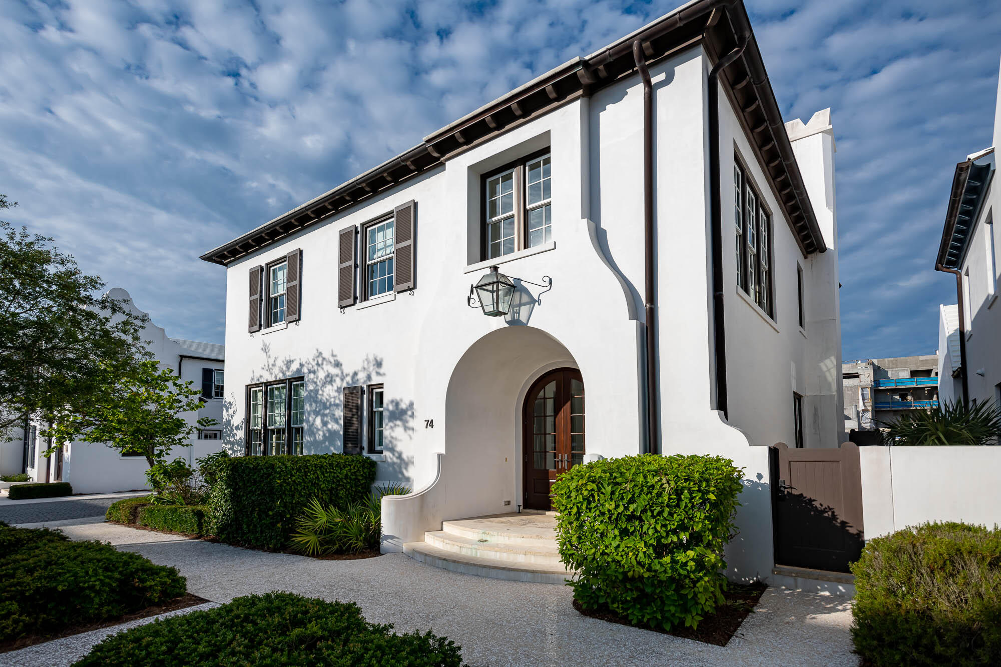 The perfect blend of elegance and a family-friendly beach home on one of the most desirable streets in Alys Beach, Nonesuch Way. Architect Gary Justiss designed the first floor with an open floor plan, first floor bedroom and two-car garage. In all, 74 Nonesuch Way has 4 bedrooms, 4.5 baths + a separate bunk room that sleeps 4. Masterfully articulated by Urban Grace Interiors, the interiors combine bright colors mixed with the understated elegance of the coastal white palette of Alys Beach. The kitchen boasts a 48 Thermador Range, 36 Thermador refrigerator, espresso machine, warming drawer, walk in pantry with drink refrigerator, Caesar stone honed countertops with a marble backsplash, island with seating and generous cabinet storage. A well-appointed laundry room is just off the kitchen. A luxurious, furnished courtyard with fireplace and Cuban tiled fountain make for a seamless transition from the living room.