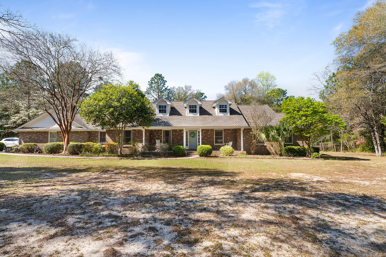 Don't let the age of this custom home fool you!   Just minutes from shopping, schools & post office sitting on almost 5+/- acres~ 4 Bedrooms, 2 full baths and 1/2 bath just off the kitchen~ Formal living and dining room and breakfast nook off the kitchen~ Den with fireplace with door opening to the back yard with an inground swimming pool~ Screened porch off the breakfast nook to enjoy the outdoors. Large laundry room and side entry garage~ Kitchen has large pantry and lots of cabinet space~ There is also a detached garage and storage building in the back yard~  Call or Text Listing Agents - DO NOT USE SHOWINGTIME