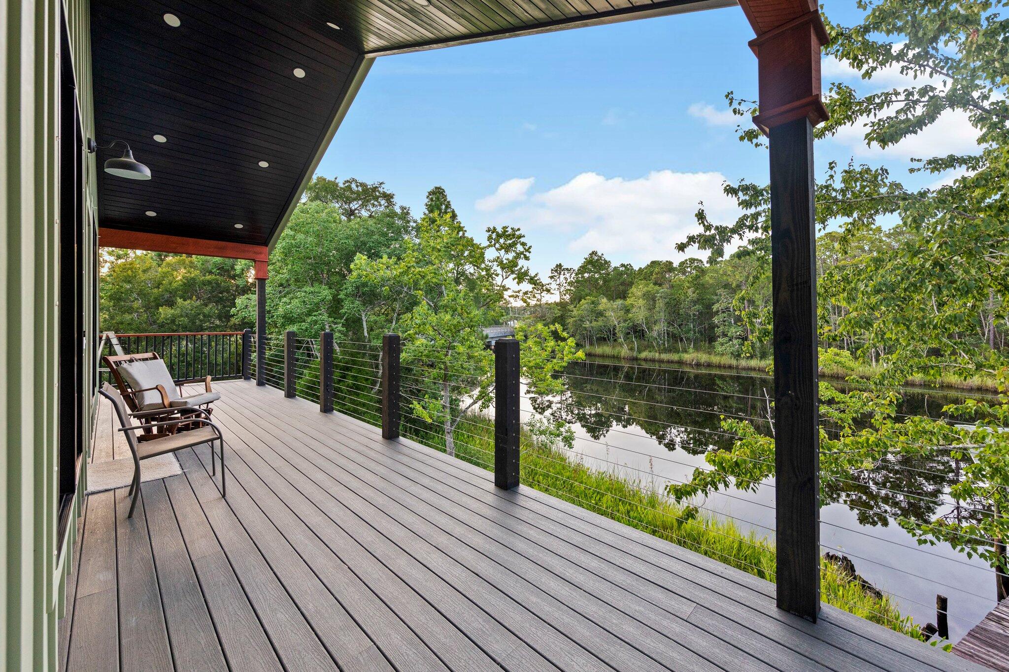 Brand new custom-built RIVERFRONT home on the East River in Navarre, built by one of the area's most respected builders. Situated on a rare oversized lot with approx. 161' of WATERFRONT on a paved road and built to Florida Hurricane Code and FEMA standards. Enjoy direct access to the Bay and Gulf with a PIER FROM HOUSE TO WATER and COVERED DOCK—perfect for boating, fishing, and waterfront living. Elevated on pilings with wraparound porches, composite decking, metal roof, and unobstructed views. Inside features an OPEN PLAN, real hardwood floors, cathedral ceilings, custom kitchen with stone counters and butcher block island, stainless appliances, and a spa-style walk-in tile shower. Comfy home that LIVES LARGE. Ideal as a primary home, getaway, or vacation Home