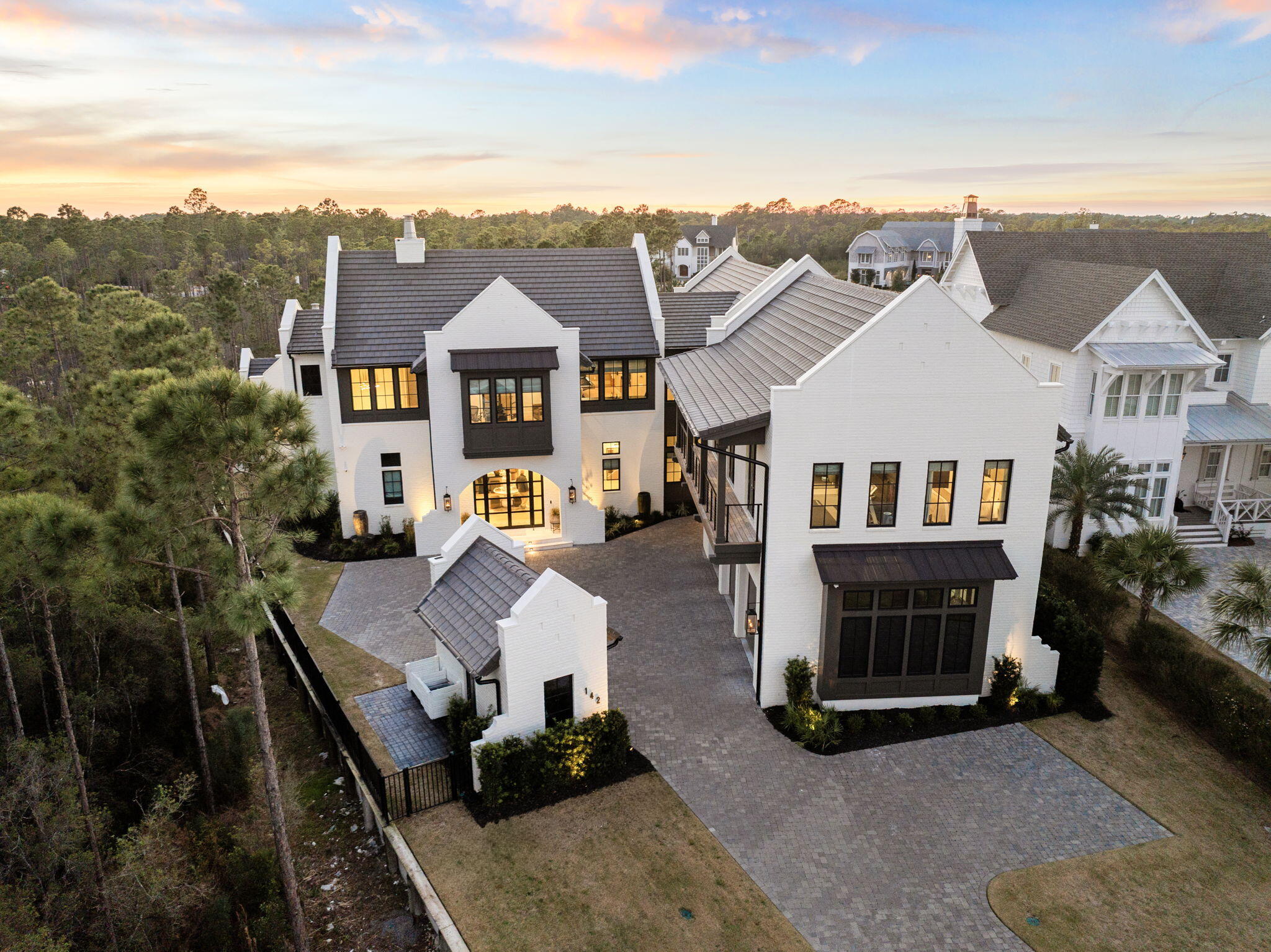 Widely regarded as one of the premier custom residences in WaterSound Camp Creek, this exceptional home exemplifies thoughtful design, superior craftsmanship, and uncompromising quality throughout. From the moment you enter, it is clear this residence was meticulously curated to deliver both elevated everyday living and extraordinary entertaining.
The gourmet kitchen is equipped with top-of-the-line appliances, including a six-burner gas cooktop, oversized Sub-Zero refrigerator and freezer, and an expansive scullery featuring dual ovens and abundant pantry storage. The open-concept living area flows seamlessly into a stunning custom bar, complete with a 450-bottle, temperature-controlled wine room, illuminated tile shelving, and an intimate pub-style ambiance rarely found in a private residence.
Floor-to-ceiling glass sliders open to an impressive outdoor retreat, showcasing a resort-style pool and oversized 14-person spa. The covered outdoor living space includes a fully equipped kitchen with gas grill, large burner, and built-in EVO flat top, along with a comfortable seating area featuring a fireplace and television. Electric screens enclose the porch, which is also pre-plumbed for ceiling-mounted gas heaters for year-round enjoyment.
The main-level primary suite offers a true spa-like experience, featuring a generous walk-in closet and a luxurious bathroom adorned with custom tile, backlit mirrors, a spacious walk-in shower, and a private built-in sauna.
The second level is accessible via both a private rear staircase and an elevator, offering exceptional flexibility and privacy. This floor includes a private two-bedroom guest suite with a full bath, living area, and built-in coffee bar, along with a dedicated home gym. Additionally, the upper level features a second primary suite with walk-in closet and expansive bath, two additional en-suite bedrooms, a large game room with a built-in fireplace, and a custom office.
Additional notable features include Venetian plaster throughout the main living areas, white oak flooring throughout the home, two separate laundry roomseach equipped with dual washers and dryersand a comprehensive Control4 system managing lighting, audio, and home automation.
This extraordinary residence is offered unfurnished.