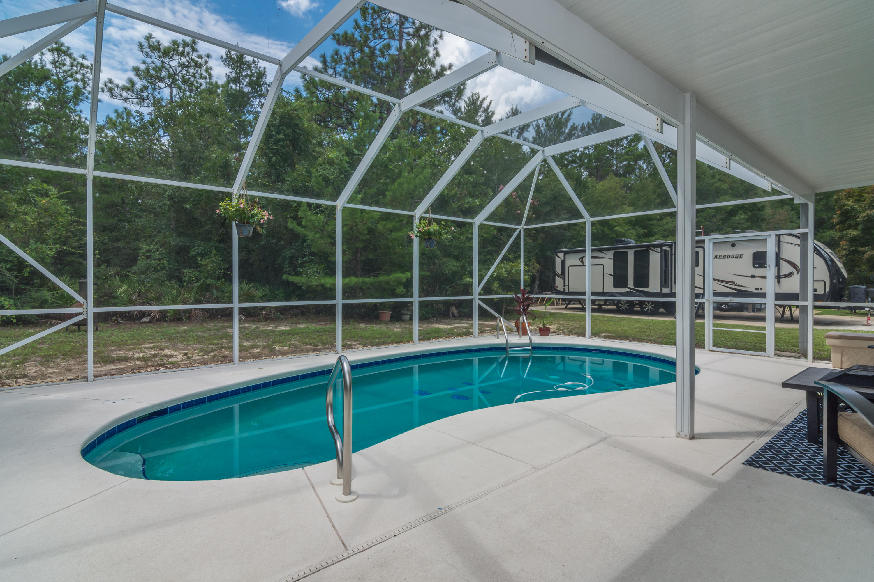 The perfect home!  Spacious, Secluded, ideally located, move in with a splash!  4 large bedrooms plus that additional 5th office space, and 3 updated bathrooms. Screened in, salt water pool to make summer fun.  So many upgrades!  Brand new flooring, fixtures, countertops.  Roof is 2018, A/C is 2019.  Kitchen is a chefs dream with endless cabinets, large pantry, and sumptuous counter space.  Closets abound, including spacious walk-in hall closets.  And a laundry shoot too! So much privacy with woods on two borders of the property, and extra parking out front. NO HOA, and a neighborhood boat dock!