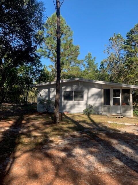 Investor/Handyman Special.  This affordable home is waiting for your TLC and vision.   The home features  two window a/c units and propane heating.  The LP tank conveys with the home.  The bright, efficient kitchen features a gas stove.  The home has a large utility room with washer and dryer hookups.  Part of the back yard is fenced in for your pets. 
 Enjoy sitting on the screened porch and enjoying the fresh air as you watch nature. 
 The home is being sold AS-IS.  The home is currently tenant occupied until 12/31/2021 and the tenant would like to continue the lease with the new owner.