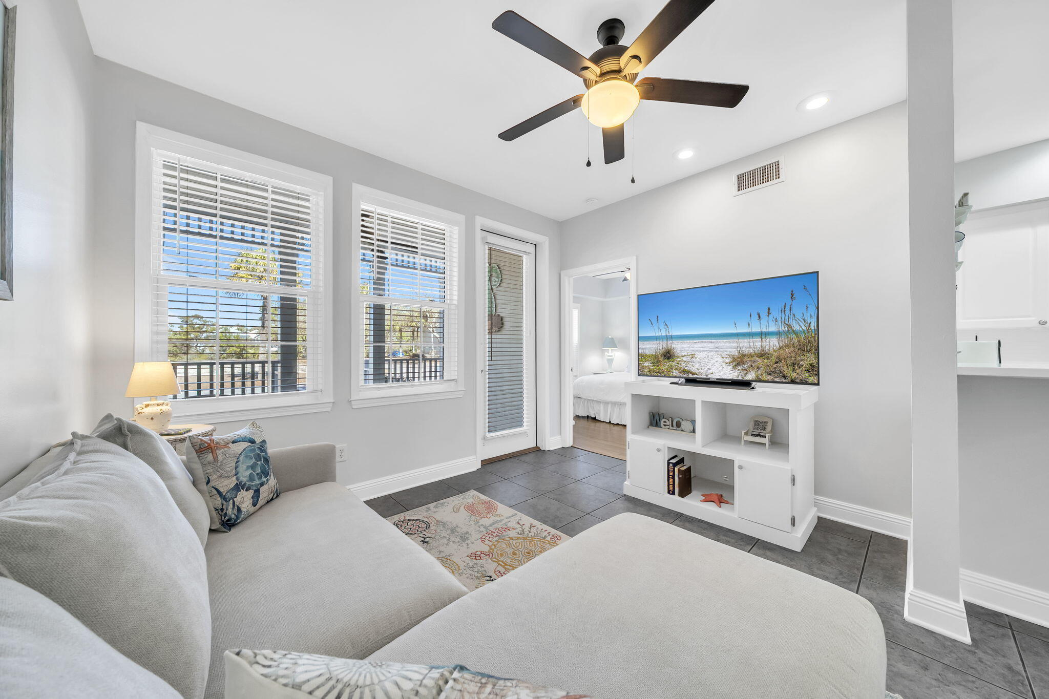 Welcome to The Village at Blue Mountain Beach a gated community located less than 1/2 mile from the sugar sand with lots of restaurants and shops only steps away. This ground floor end unit has lots of natural light with an open floor plan kitchen/living/dining. It also boasts three bedrooms with an ensuite primary bath and large closet on one side and the other two bedrooms and hall bath on the other. This unit is truly turnkey with fresh paint, brand new appliances and brand new furniture.  You'll find beautiful coastal décor throughout the unit making you feel relaxed and ready to enjoy 30A living. You'll also want to sit on the front porch and enjoy the quiet community or take advantage of the abundance of amenities. This beach retreat is perfect for a rental income property or a full time owner's enjoyment