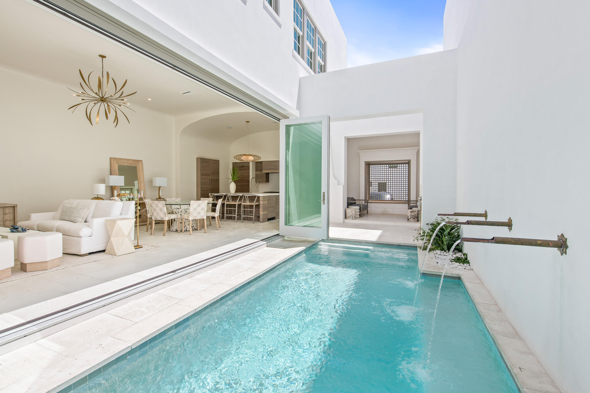 16 Kings Castle Court is the epitome of coastal luxury living. This quintessential home boasts an ideal location along Alys Beach's prestigious Turtle Bale walking path and was designed by town architect Khoury Vogt. The open floor plan, outdoor living spaces and incredible views from the rooftop terrace embody everything you could dream of in a luxury beach home. As soon as you walk into this home, you will immediately be impressed by the gorgeous water features and twelve foot ceilings that direct you to the luxury chef kitchen with state of the art stainless steel appliances and custom designed cabinetry by Kingdom Mills. The open living room is accented with massive bi-folding doors that exhibit the true feeling of indoor/outdoor living at Alys Beach, and the courtyard has an outdoor living space and summer kitchen to enjoy the truly exceptional year-round weather.
This lifestyle home offers two master bedrooms: one on the first floor and one on the second. The first floor master suite is accented with handpicked tile and a custom design architectural vanity. The second floor main master suite is adorned with a whitewashed pecky cypress ceiling, and its private ensuite bathroom features marble floors with an accented marble wall to showcase the stand alone tub. The main master ensuite also includes a walk-in shower and two separate side by side walk-in closets.
There are also two additional guest suites on the second floor, each with a single vanity and walk-in shower. As you enter the additional guest suite you are greeted with a long custom designed arched hallway that makes this fourth room very private. This guest suite has a large custom designed vanity, separate water closet and large walk-in shower.
One of the true gems of this home is the third floor rooftop terrace, with wet bar and incredible northern, southern, and eastern views of Alys Beach. Bottom line, this home one hundred percent embodies all that Alys Beach has to offer and is just steps from sandy white beaches and the emerald green waters of the gulf. Buyer to verify all dimensions.
