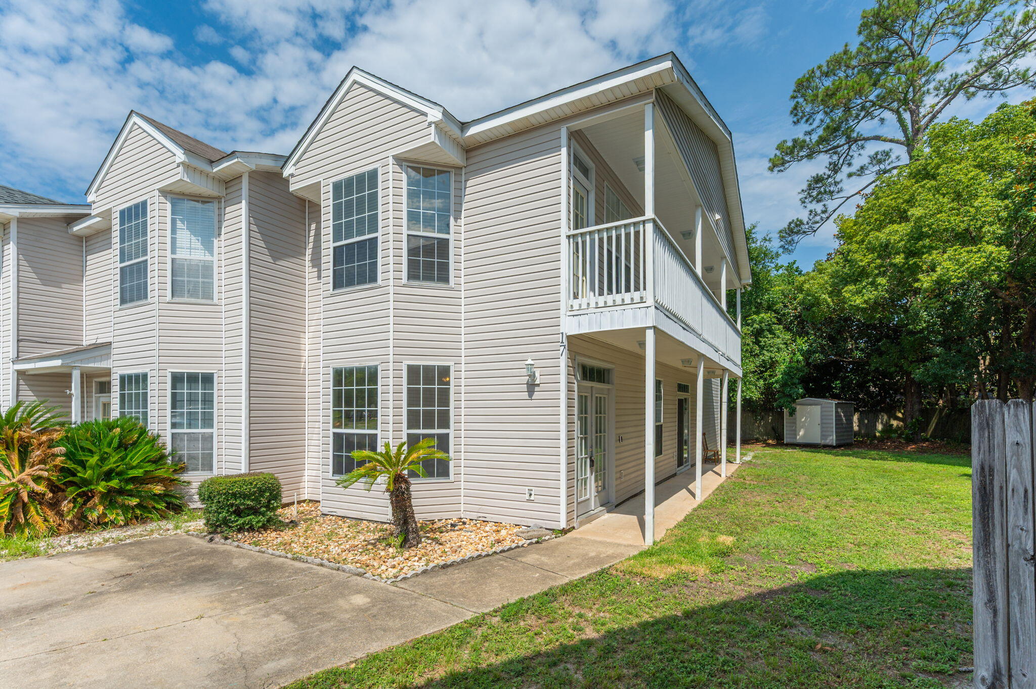 Welcome to this beautifully designed three-bedroom, three-bath townhome located in the heart of Fort Walton Beach. Step inside to find luxury vinyl plank flooring throughout the main living area, complemented by a bright bay window that fills the living room with natural light. The kitchen features a convenient center island, sleek black appliances, a pantry, and a peek-through cutout connecting to the dedicated dining space—perfect for entertaining. Downstairs, you'll find a full guest suite with a painted accent wall, along with a generously sized bathroom vanity and ceiling fan. Upstairs is fully carpeted and includes a second guest room, full bath, and the spacious primary suite. The primary suite boasts a bay window with access to a private balcony, a double vanity, and custom shelving in the walk-in closet. With thoughtful design elements and plenty of natural light, this townhome blends comfort and function in a highly desirable location. Contact us today for your showing!!