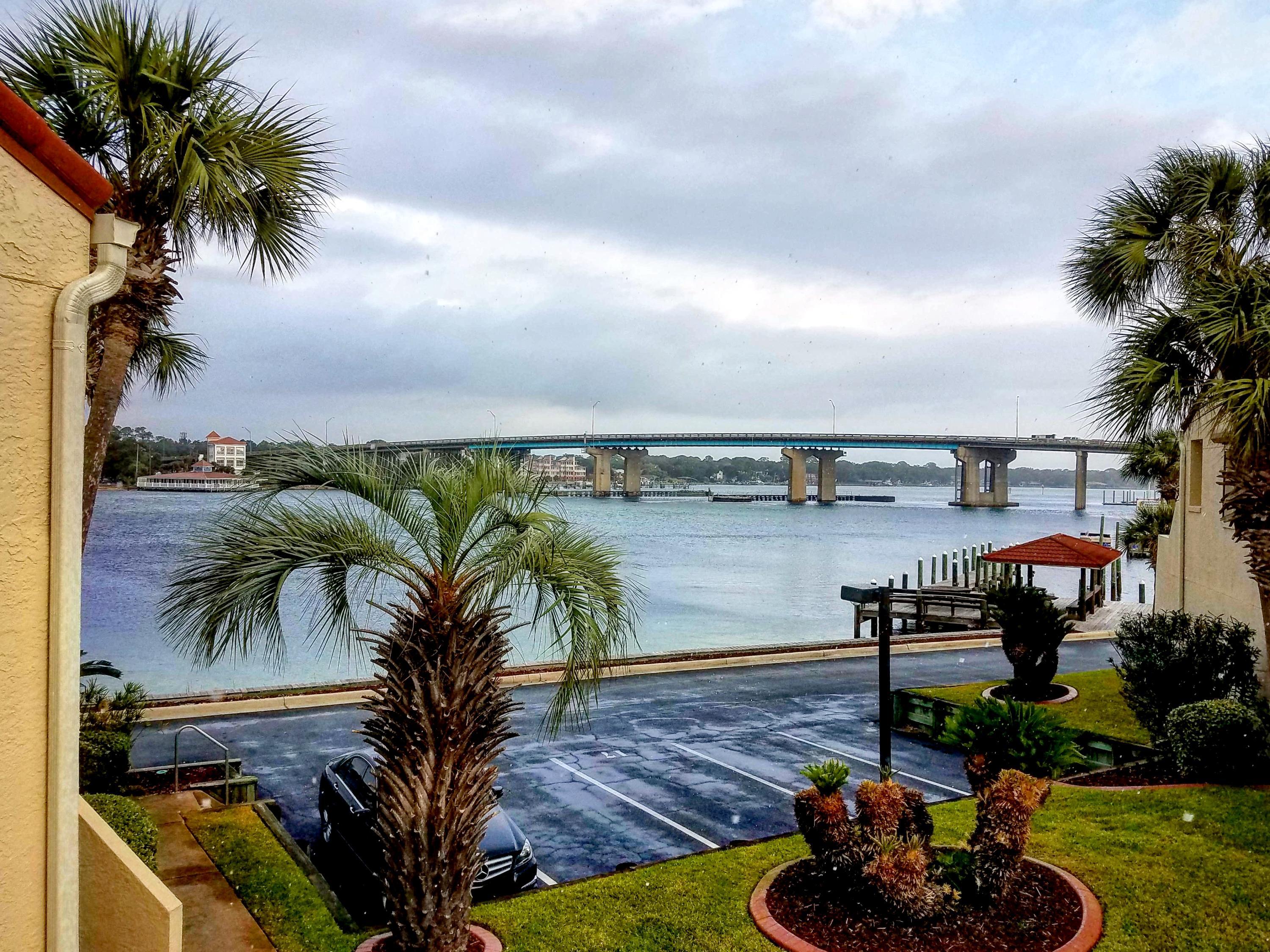 PRICE REDUCED! Only unit in the complex for sale! Amazing view of the sound from the living room. These units aren't for sale very often. A 50' deep water boat slip conveys with unit! The living room has luxurious pewter grey planks, tin ceiling, modern ceiling fan, nautical cedar encased beam, HVAC is one year old, water heater is less than a year old. A very short walk to the beach via the boardwalk behind the complex! The entrance is into the living room and kitchen, where there are vaulted ceilings, a half bathroom and laundry area (with washer and dryer). Wood stairs lead to the ground floor,2 bedrooms and each have their own bathroom.There is a downstairs patio.The unit has no carpet. Sailboat in slip is negotiable separately. If rented, has to be min 6mo lease and a balcony off of the living room upstairs overlooking the Intracoastal waterway and Brooks bridge. There is also a storage closet under the stairs.
