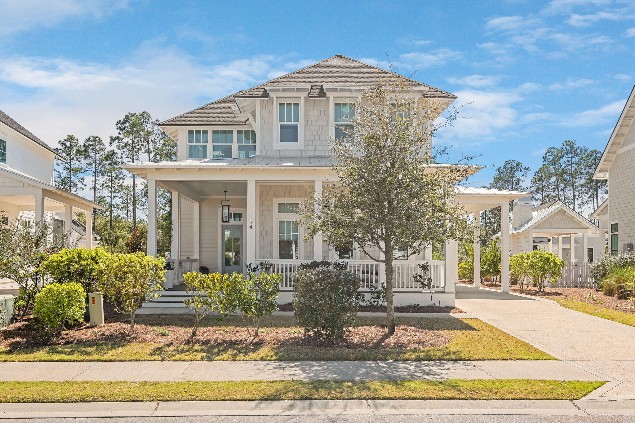 Stunning Custom Home in Watersound Origins - 194 Sawbuck Dr.
Built in 2021 and meticulously maintained by its original owners, this 4-bedroom, 4.5-bathroom custom home by Cole Homes, with interior design by Libby Baker of Baker Designs, offers timeless elegance and modern luxury in the sought-after Watersound Origins community. Step inside to: 12-foot ceilings on the first floor, vaulted ceilings and 10-foot ceilings on the second floor, Vanilla Milkshake colored shiplap walls, white pine wood flooring, double crown molding, 6 inch base molding, transom windows, custom blinds, upgraded fans with remotes, custom designer lighting, custom designer hardware throughout and two nest thermostats. Not a detail was overlooked.  The chef's kitchen features an oversized extended island with a granite waterfall edge with custom lighting and handmade Moroccan tile backsplash. The kitchen boasts top of the line high end appliances including a Dacor 6-burner dual fuel range, Wolf hood, Sub-Zero fridge, and Bosch convection and microwave oven.  Ample custom cabinetry in the kitchen including all lower soft close drawers (in lieu of cabinets) is a practical upgrade. A barn door leads to the laundry/utility/pantry room, complete with a wine fridge and sink. The first-floor master suite is spacious and offers room for a seating area and boasts a mirrored barn door to the master VA/ADA compliant yet beautiful and spa like master bathroom with custom tile, a zero entry shower with both a rain and a hand held shower head. Do not overlook the toto neorest toilet.  The Neorest series represents the pinnacle of totos technology and is a  fully integrated smart toilet with built in bidet functions, automatic flushing, self-cleaning technology and an adjustable heated toilet seat. The master walk-in closet is custom with three tier built-ins, with the top shelf offering pull-downs to utilize the ceiling height. The entry way of the home is welcoming and offers a unique hidden under-stair playroom/storage space and opens to the spacious staircase with custom runner carpet and a beautiful custom chandelier.  Upstairs the bonus living space is light and bright and has a cathedral ceiling and leads to three additional bedrooms each featuring ensuite baths with custom tile and hardware and built-in shelving in the closets. The property is .367 acres and offers a long driveway providing ample parking and a port cochere along the side entry of the home (that leads to the kitchen) and a 2-car garage with epoxy flooring, 12-ft ceilings, and 6 electrical outlets. There is an adjoining outdoor shower and potting shed. The beautifully landscaped property has a 5-zone irrigation system utilizing reclaimed water and features mature trees, hydrangeas, azaleas, rose trellises, and French drains and a fountain - plus there is ample room for a pool! The wrap around screened back porch is 520 SF and is accessible via a VA/ADA compliant ramp which is tastefully and seamlessly part of the home and could easily be removed if needed. The massive screened porch offers a gas line for your grill, an alfresco dining area, an additional seating area and a lovely porch swing!  The home also offers a large welcoming front porch. This property also has solar panels which provides the homeowners with nearly all of the electric that the property needs resulting in a minimal monthly electric bill. Although the current property owners do not have surround sound the property is wired for it and it could easily be added. The lot is large and extends approximately 65 additional feet from the back of the garage for the entire width of the property, adding value and an open canvas of possibilities for uses. The property is in the coveted Watersound Origins neighborhood. This premier community offers resort-style amenities, including a residents-only pool, fitness center, miles of walking & biking trails, a golf course, tennis & pickleball courts, basketball courts, a community garden space and access to Lake Powell for paddleboarding & kayaking. The Origins Golf Course, designed by Davis Love III, provides an exceptional golfing experience. Plus, enjoy convenient access to 30A's white-sand beaches, upscale dining, shopping, entertainment, Publix and schools. This property has it all and is a like-new home and a rare find in an unbeatable location. Schedule your private showing today!