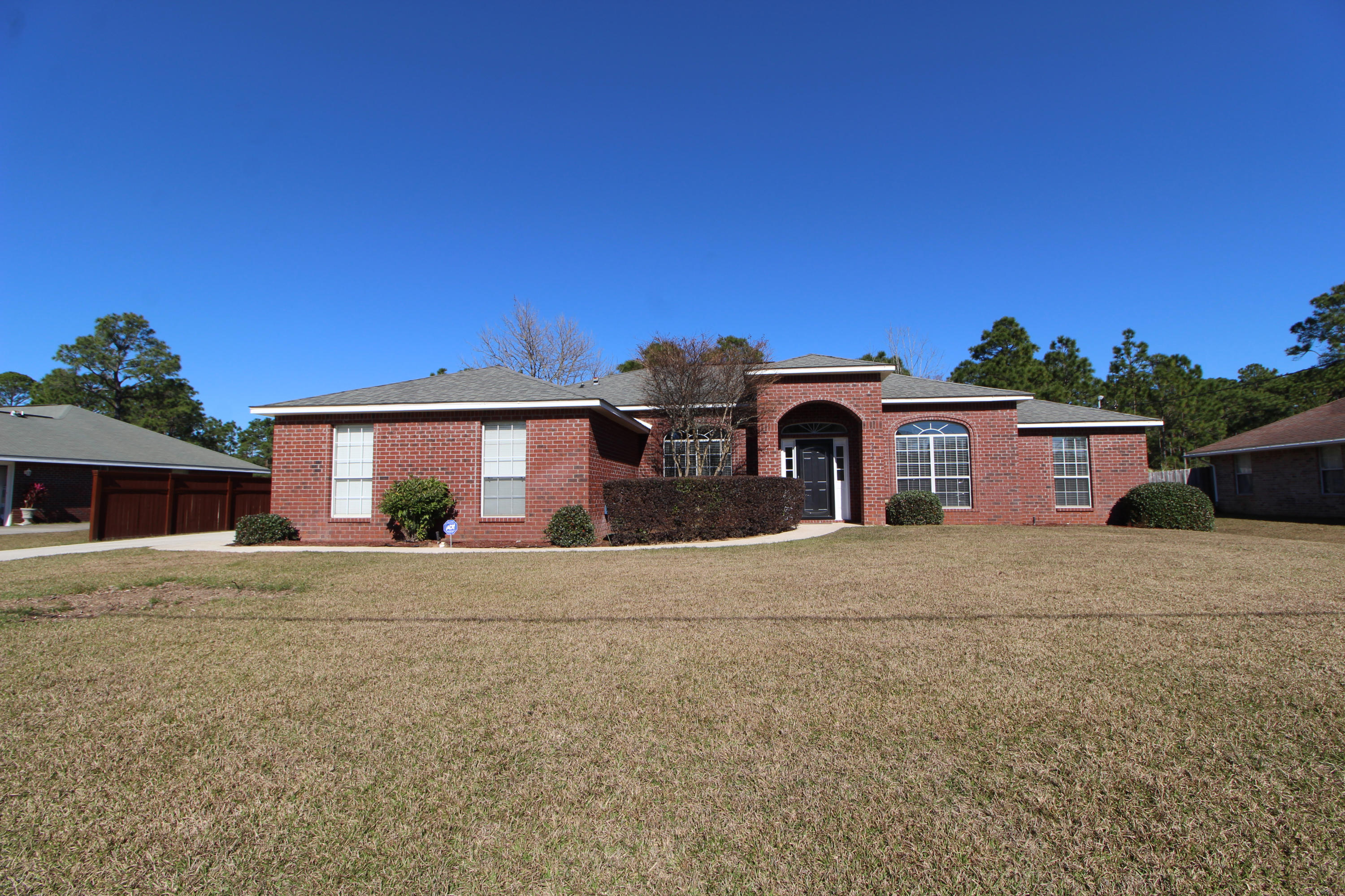 Wonderful all brick home situated on almost 3/4 acre lot on a quiet street in the desirable Holley by the Sea Community! Spacious living room with vaulted ceiling, corner fireplace with tiled front and mantle and sliding glass door that leads out to the patio and private backyard. Formal dining room with raised ceiling and a arched accent window. Light and bright kitchen with lots of counter space, plenty of cabinets, center island and large pantry. Breakfast area is placed in a wide bay window that overlooks the backyard. Master bedroom has trey ceiling with a remote control designer ceiling fan. Master bath with large walk-in closet, double vanities, whirlpool tub and separate shower. Split bedroom floor plan allows you additional privacy from guests or kids. Front bedroom would be perfect for a office/den.  Two additional bedrooms and a full bath complete this home.  Fully fenced beautifully manicured backyard offers you lots of privacy, lawn pump and sprinkler system.  New water heater 2018 and HVAC 10/2017.  Homeowners Association membership allows you access to all of Holley by the Sea amenities including membership to Holley by the Sea's multi-million dollar 45 acre recreational center with 8 tennis courts, 3 swimming pools, full gym, exercise classes, summer camp, lighted basketball courts, sauna & steam room, playground game room, community house on Santa Rosa Sound with playground, dock, access to the East Bay boat launch and many community events. Only minutes to the pristine white sugar sand beaches and emerald water of the Gulf of Mexico. Call us today to preview this home.....
