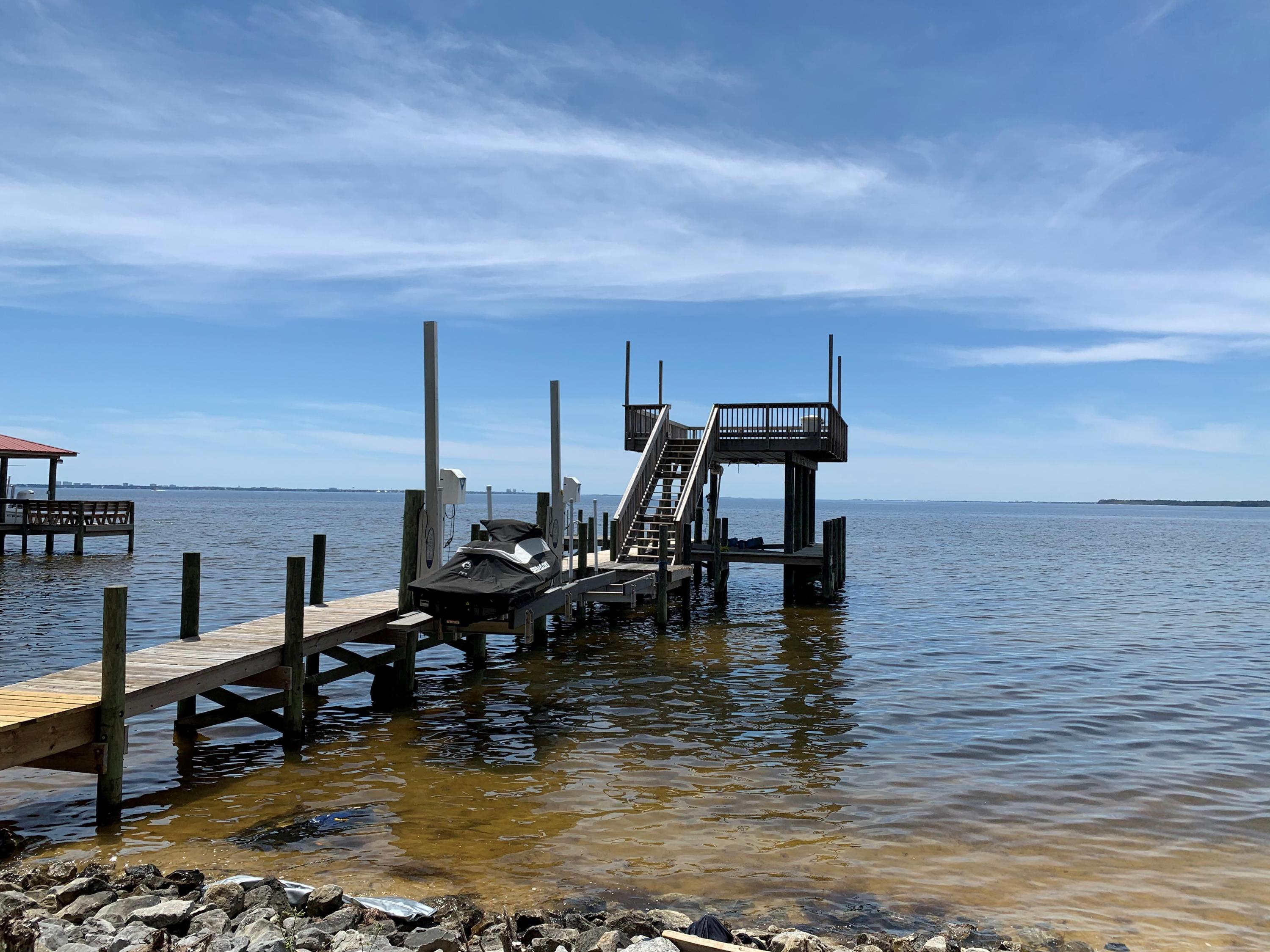 Location!!! Location!!! Rare opportunity to build the waterfront home of your dreams in Bluewater Bay. Nestled on 90' of the Choctawhatchee Bay with sweeping views of Destin and unparalleled sunsets. Complete with a boat lift and 2 ski lifts, the multi-level private dock allows quick and easy access fishing, Crab Island or, head to the upper deck of the dock and relax.