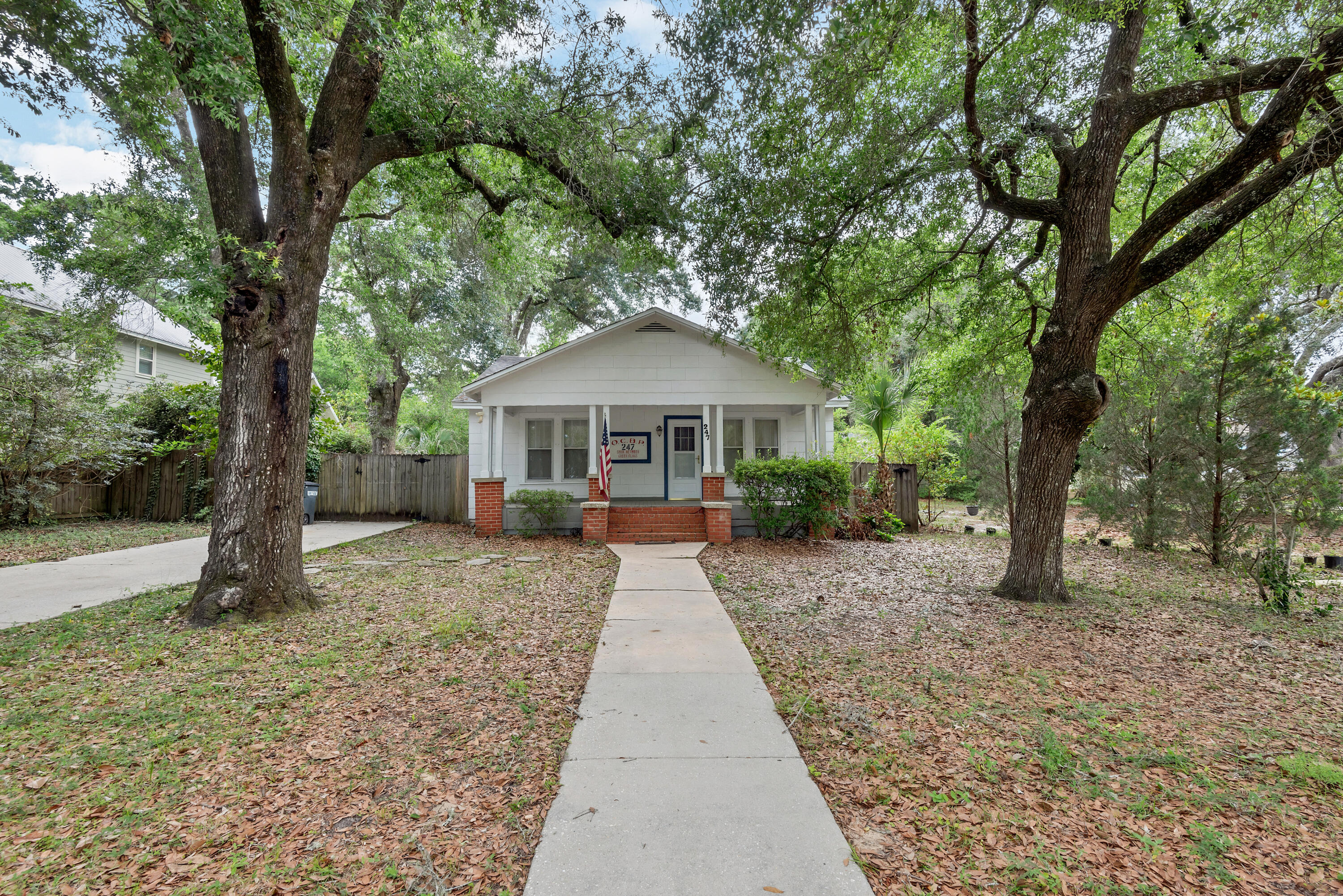 This is your opportunity to own a true Florida Cottage! This two-bedroom, one bath is boasting with charm and centrally located in Valparaiso. The dining and living space are separated by French doors to add to the character of this home. Tons of windows leave natural light throughout each room. This property features a spacious front porch, perfect for enjoying your morning coffee! The large backyard has tons of potential, with closed in sunroom/porch off the kitchen!  Steps away from the Emerald Coast waters. The large kitchen features stainless steel appliances and window over the kitchen sink. Rare opportunity to own close to the water!