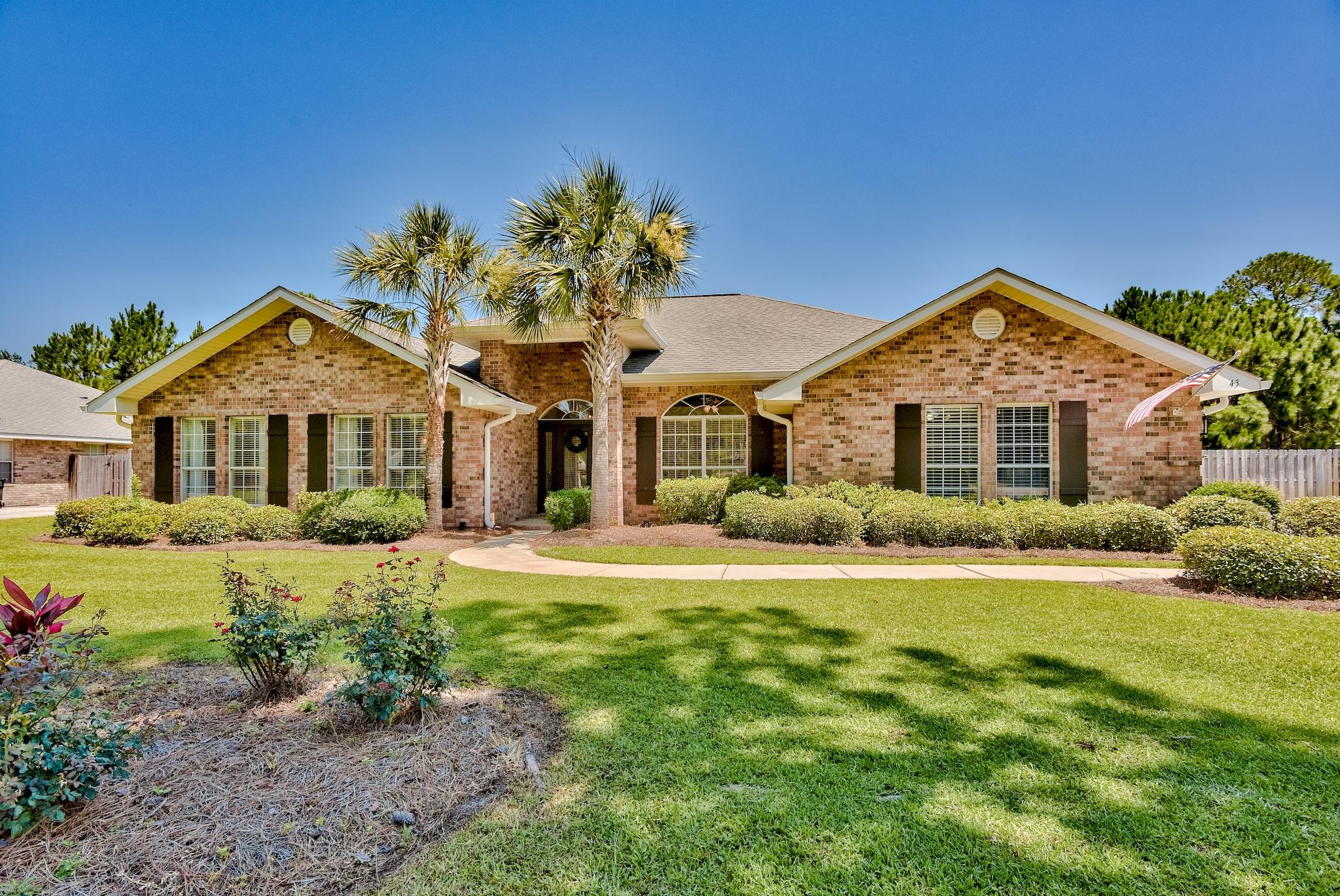 Updated in beautiful southern elegance...come home to this all brick, 3000 SF, 4/3 in Driftwood Estates. Vaulted ceilings in the living room, with gorgeous shiplap accents and a corner fireplace. All white/grey cabinetry, stainless appliances, granite counters, cased windows, stylish lighting and fixtures, and gorgeous wood look tile floors throughout! The master bath is a retreat, with a luxurious whirlpool bath, tiled shower, and double walk in closets. Large patio perfect for entertaining with a double gate to the back yard on over a half acre site. This is a spotless home and all the upgrades have been done. Driftwood Estates is a family friendly neighborhood with a park, tennis courts and so close to all your shopping needs, work, and the beach!