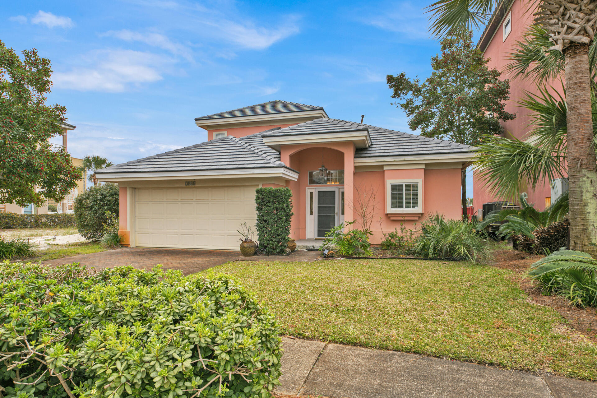 A perfectly situated home on the South side of 98, located directly on the lake on a quiet cul-de-sac, inside the gorgeous gated community of Dunes of Destin. Boasting 3 bedrooms and 2.5 bathrooms spread out over two stories, this home is not to be missed! The first floor has tile throughout the main living areas, a large kitchen with ample cabinet space, a breakfast bar, spacious dining/living area with vaulted ceilings, and large master suite. Upstairs you will find two more bedrooms, one which has outdoor access with gorgeous lake views, and another full bathroom. The back patio offers a serene area overlooking the lake to enjoy your morning coffee or alfresco dining. A dune walkover very closeby the home leads you to the deeded beach access with over 600 feet of private beach and the  community pool! This home has a brand new roof and will convey with a golf cart and charger. Dunes of Destin is in the perfect location with a short walk to many restaurants, shopping, and a short drive to everything the area has to offer!