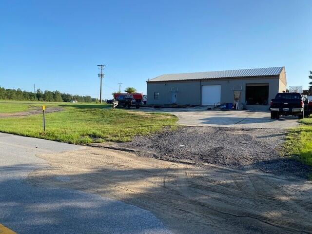 Zoned HEAVY INDUSTRIAL!! Huge income potential.  Great location. Minutes from I-10. Minutes from the beach. The largest property around with this zoning. Two driveways. 2 offices, 2 stories, 2 bathrooms, 2 bay doors, 1 loading dock. Half the property is still wooded. The turn lane for 331 and Edgewood is in front of the property for easy access.