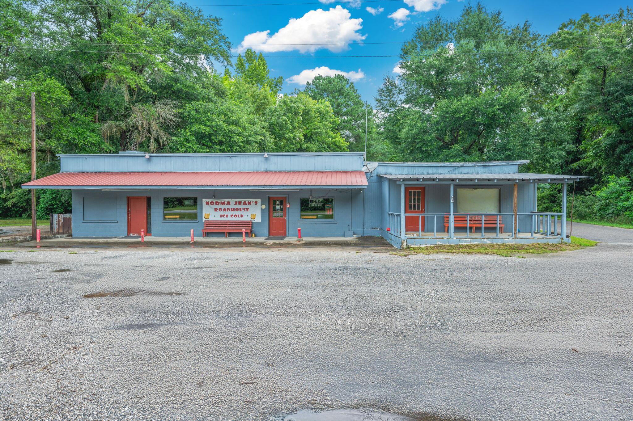 Live, Laugh, Lounge. Your Business Dream Starts Here with +/- 90ft of US Hwy 90 frontage! Ready to pour up profits and crank up the fun? This 2,103 sq ft commercial gem on .37 acre is more than a building, it's a full blown good time headquarters, waiting for its next owner to make a splash in the nightlife or entertainment scene. Step inside to find a spacious L-shaped bar outfitted with triple and double coolers, and plenty of elbow room for slinging drinks and making friends. There's even a serving window to the 28' x 24' patio, perfect for outdoor vibes and sunset sips. Got talent? Showcase it! With a karaoke stage, live music stage, and DJ booth, this place is set for entertainment. Add in the pool tables, tables and stools, and you've got all the ingredients for a crowd-pleaser. Two bathrooms, a dedicated storage room/office, and a 12 X 24 storage shed. The best part? It's turnkey, just unlock the doors, set up your equipment & your playlist, and watch your business come to life.Cheers to your next adventure. The stage (and keys) are waiting!
And if bar life isn't your thing, don't worry, this versatile space offers plenty of other commercial opportunities. Let your imagination run wild!