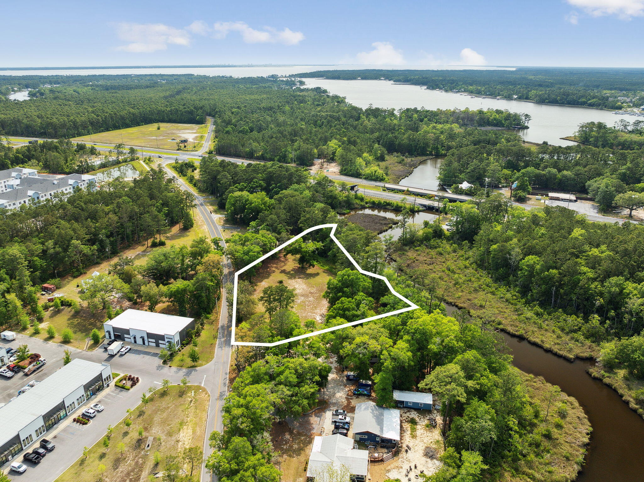 Discover the ultimate opportunity for builders and boating enthusiasts at 193 Ramsey Branch Road, a prime waterfront property located at the southern end of Freeport. Spanning approximately 1.7 acres, this vacant land offers an approved development order for 12 luxurious waterfront townhomes, each boasting up to 3,000 square feet and a height of 45 feet. With an impressive 460 feet of waterfrontage, this site provides unparalleled access to the serene waters of the creek, bay, beach, Crab Island, and the Gulf, making it a boater's paradise. Each townhome can feature its own boat dock, allowing residents to enjoy direct access to the water and the convenience of a boat ramp on site. This unique offering is perfectly positioned near the stunning Beaches of South Walton, providing easy access to the area's renowned sandy shores and vibrant marine life. The property is zoned RC Residential/Neighborhood Commercial, offering flexibility for a variety of development possibilities. Future residents will appreciate the proximity to local shopping and dining options, ensuring that everyday conveniences are just moments away. This waterfront land is a rare find, combining the tranquility of coastal living with the excitement of boating adventures. Whether you're looking to develop a luxurious residential community or a mixed-use neighborhood, 193 Ramsey Branch Road presents an exceptional investment opportunity in a sought-after location. Embrace the potential of this builders' and boaters' paradise and create a waterfront lifestyle that dreams are made of.