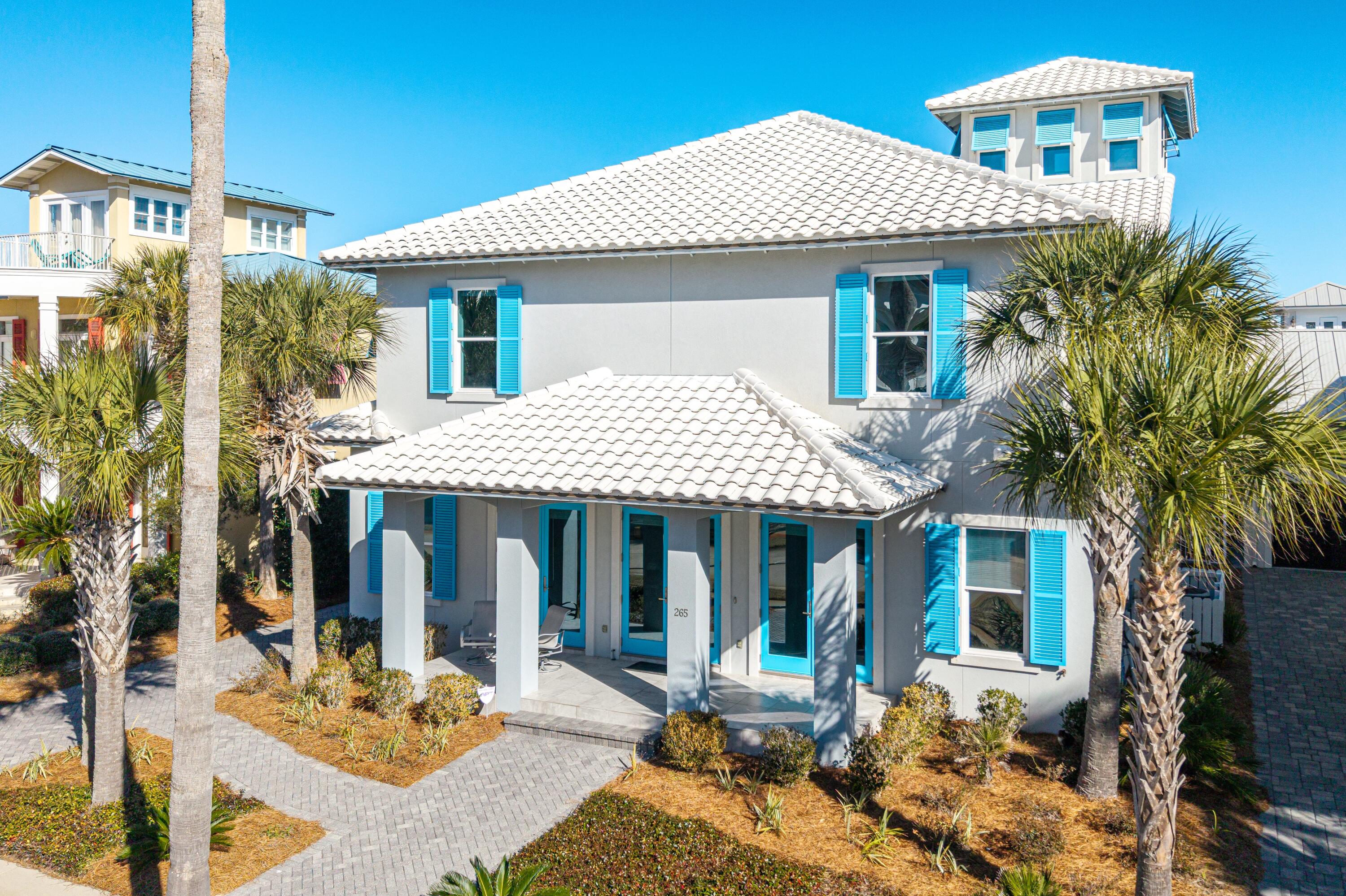 Gulf-View Living in Guard-Gated Caribe. Set just steps from Caribe's quiet, sugar-white shoreline, this thoughtfully designed coastal home delivers an easy, modern approach to Gulf living—bright, open, and built to last. Constructed by Boswell Builders, the residence reflects a minimalist philosophy where durability, comfort, and fun take center stage. Offered fully furnished, the home is ready to be enjoyed from day one.

Spanning 4,332 square feet, the interior unfolds with clean lines, light-filled spaces, and unfussy finishes that feel both current and timeless. The main living areas are open and inviting, designed for gathering without excess—perfect for full-time living, long weekends, extended stays, and effortless entertaining. The kitchen anchors the home with generous workspace, streamlined cabinetry, designer appliances, and an intuitive flow to dining and living areas.

With five bedrooms and four baths, the layout offers flexibility for family and guests alike. Upstairs, a dedicated playroom was intentionally designed for movement and imaginationtumbling, games, and laughter encouraged. Even the pool table conveys, reinforcing the home's playful spirit. A separate viewing lounge on the upper level opens to its own breezy balcony, where endless Gulf views and unforgettable sunsets become part of the daily rhythm.

Outdoors, the property truly distinguishes itself. One of Caribe's most spacious backyards provides a rare sense of room to roam, featuring an in-ground hot tub, outdoor kitchen, and ample space for gathering, relaxing, and celebrating coastal life. It's a backyard built for long afternoons, barefoot evenings, and easy entertaining.

Additional features include a single-car garageideal for beach gear and daily essentialsalong with thoughtful storage and a layout that prioritizes living over maintenance.

Located within guard-gated Caribe, residents enjoy private beach access, community pools, tennis courts, and a setting that feels both protected and peaceful. Short-term rentals are permitted with restrictions, offering flexibility for personal use or investment.

This is modern coastal living without pretensebuilt for longevity, designed for play, and framed by Gulf views you'll never tire of. Come experience Caribe at its most effortless.