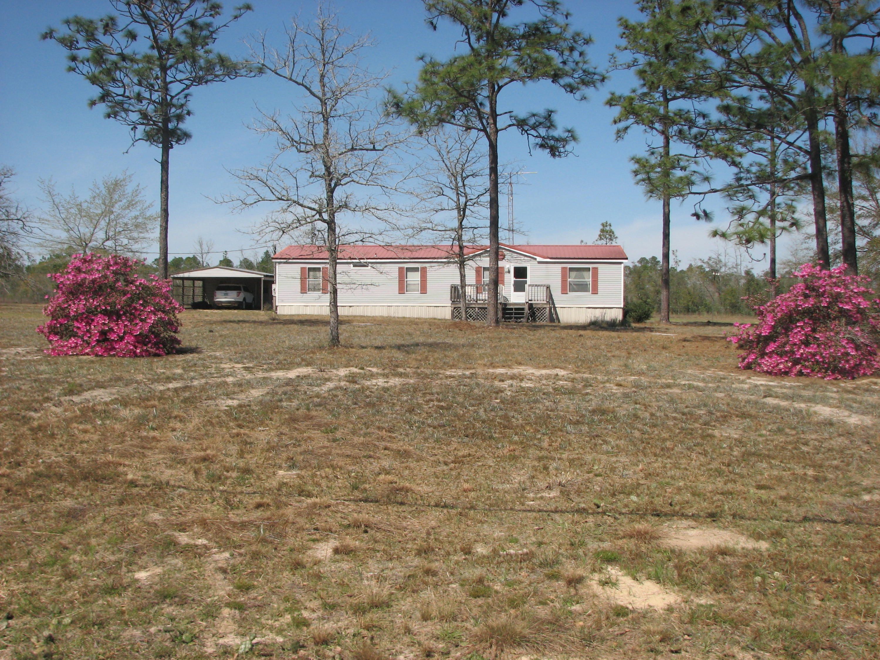 THIS ONE OWNER MANUFACTURED HOME OFFERS PLENTY OF SPACE AND PRIVACY ON 2 FLAT ACRES, YET ONLY MINUTES FROM TOWN. DETACHED WORKSHOP WITH 2-CAR COVERED PARKING, DECK ON THE BACK FOR RELAXING IN THE EVENINGS, PORCH ON THE FRONT AND SIDE. INSIDE YOU WILL FIND A LARGE GREAT ROOM WITH WOOD BURNING FIREPLACE, SPLIT BEDROOM FLOOR PLAN, SOAKING TUB IN MASTER BATHROOM, GOOD SIZE CLOSETS IN ALL BEDROOMS. OWNER IS LEAVING REFRIGERATOR AND WASHER. METAL ROOF PUT ON IN 2005, SEPTIC TANK PUMPED IN 2015, SECURITY SYSTEM IN PLACE. CALL TO SEE TODAY!