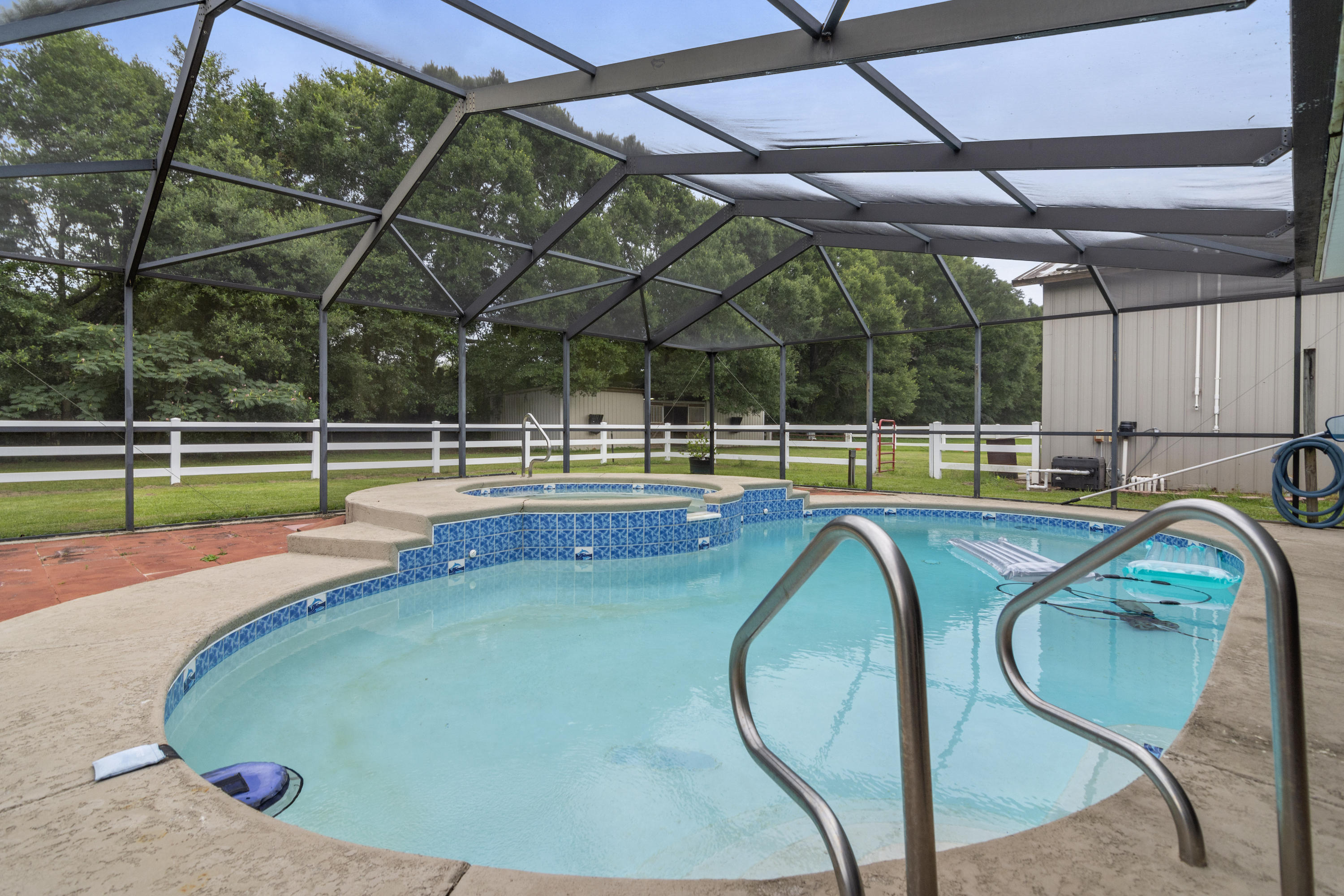 Gorgeous horse estate waiting for its next owner!  This property has it all! Sparkling gunite pool and 10 foot spa completely screened, Huge, fully insulated enclosed pole barn, additional 3 stall horse barn, two fenced pastures, 4 car garage, and so much more!  Home has 3 large bedrooms plus two offices, second living room/media room, screened porch, uncovered wood entertaining deck, and upgrades galore.
This home does not disappoint with wood floors throughout, granite counter tops, double ovens, stainless appliances including wine fridge, upgraded fans and fixtures and several built-ins making this a place to call home!  TANKLESS WATER HEATER 2013, gas lines and pool heater, New ROOF 2020, HVAC 2018.