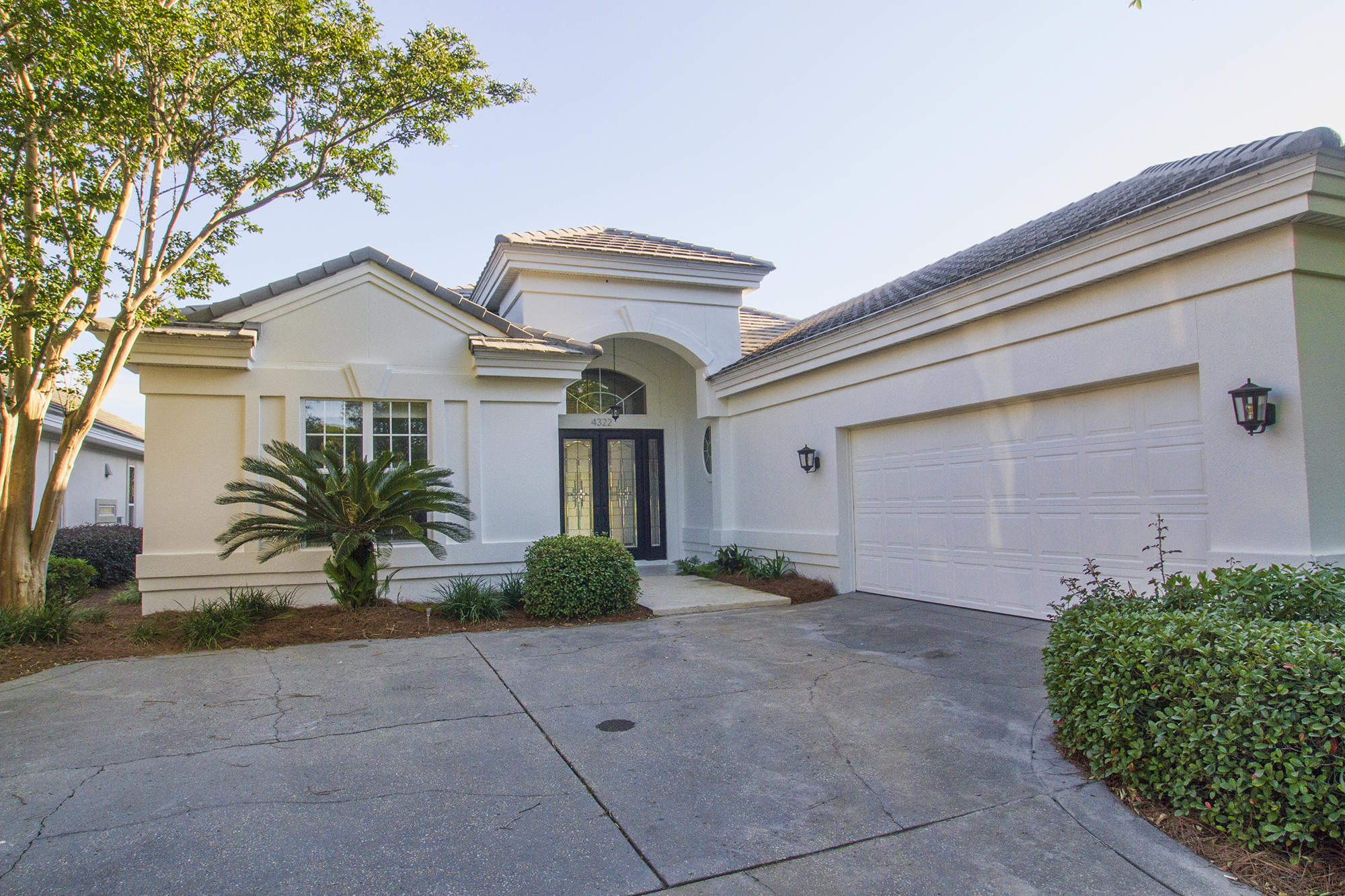 Ready to in enjoy immediately! Freshly painted exterior (Greek Villa White painted May/2020). The home features many additional updates such as new carpet, crystal hardware and lights in crisp white master bath,
remodeled pool and more. Nestled inside the gated community of Kelly Plantation, 4322 Carriage Lane is a lakefront masterpiece ideally positioned to overlook the 14th fairway of Kelly Plantation's iconic golf course. This property holds a demeanor of traditional elegance while boasting bold features including an awe-inspiring lakefront pool and fountain. Capitalizing on the vast views, this single-story residence features an abundance of both sliding glass doors and windows, truly allowing for the outside views to encompass the indoor living space. The noteworthy kitchen features custom all wood cabinetry with soft closing hinges, eye-popping granite, elegant tile back splash, kitchen island, all stainless-steel appliances, and concluded with a breakfast nook overlooking the lake. Adjacent to the kitchen lays the formal dining room with sophisticated crown molding and a chic hanging center piece.

The master suite offers some of the best views from the entire residence and is accompanied by a grand master bathroom. The master bathroom features a stunning walk-in shower with floor to ceiling tile and a separate soaking tub for added relaxing. 

Other notable features include beautiful arch ways throughout the residence and the garage that features a separate garage door perfect for a golf cart. This is great primary or second home. The yard maintained by Brightview landscape company. Low tax rate!