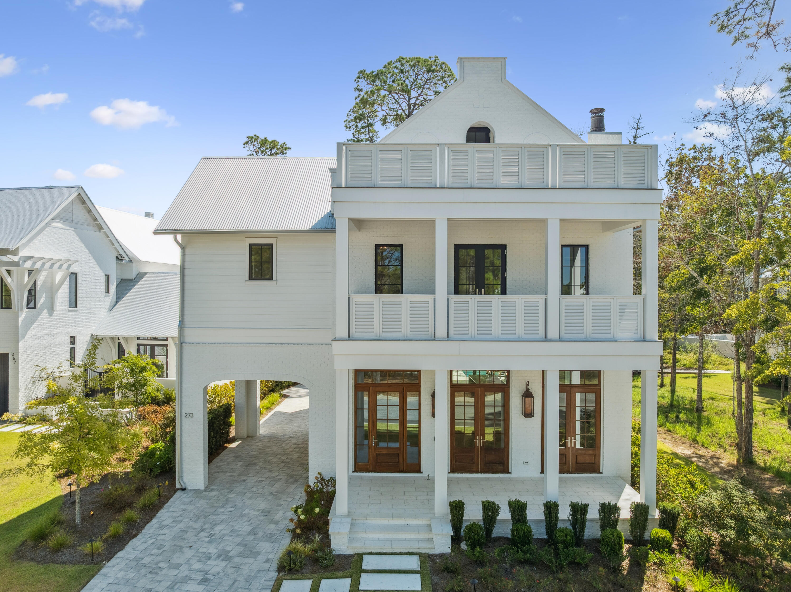 Set within the private gates of Churchill Oaks, 273 Churchill Oaks Drive blends thoughtful design, versatile living, and effortless access to the coastal lifestyle. Located in this premier bayfront community, the home offers over 4,000 square feet of refined living space, including four bedrooms, four-and-a-half bathrooms, and a private carriage house—perfect for guests, extended family, or a dedicated home office. The spacious great room, anchored by a gas fireplace and framed by an abundance of windows and doors, sets the tone for the home's mix of traditional elegance with modern touches. The custom chef's kitchen, equipped with Miele appliances and quartz countertops, flows seamlessly to the outdoor entertaining area, complete with a private pool and summer kitchen, making indoor-outdoor living effortless. A private elevator or the beautifully designed staircase leads to the second floor, where the master suite boasts a balcony overlooking the bayou and a spa-inspired bathroom with dual vanities, a soaking tub, and a walk-in shower. Three additional bedroom suites continue the theme of wide-plank floors, custom cabinetry, and clean, crisp tile throughout the home. The third-floor space offers flexibility as a gym, theater, library, or additional sitting area.

The carriage house is a true bonus, featuring its own kitchenette, living room, and separate bedroom, providing privacy and comfort for visitors or anyone needing personal space. Multiple covered porches, open patios, and poolside living ensure the home's outdoor spaces are as inviting as the interiors. Residents also enjoy access to Churchill Oaks' resort-style amenities, including a bayfront clubhouse, fitness center, and a deep-water marina with 36 private boat slips.

273 Churchill Oaks Drive isn't just a home - it's an invitation to embrace the relaxed elegance and endless possibilities of life on the Emerald Coast.