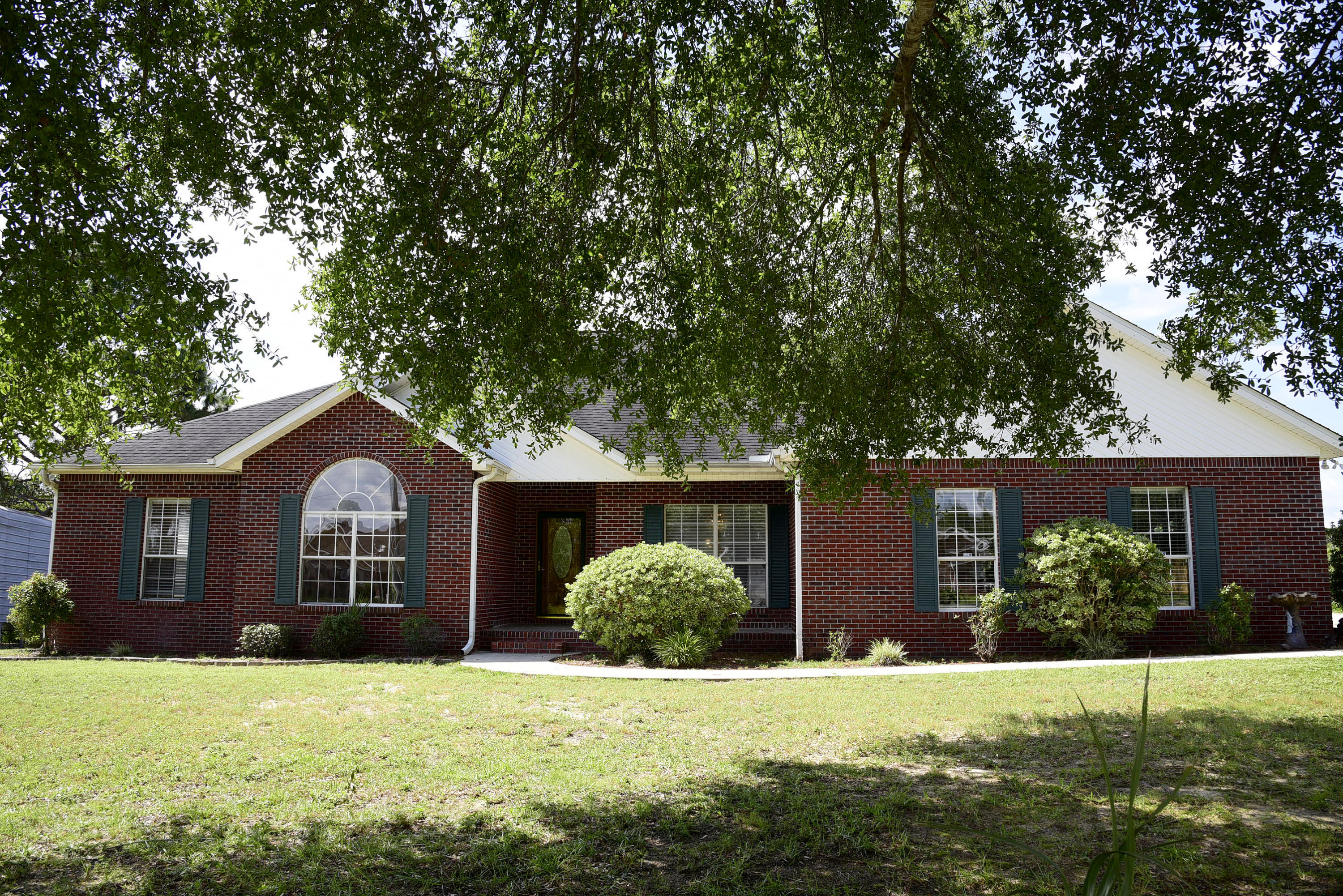 This all brick lakefront home also has a NEW ROOF and a tankless Rinnai water heater! The beautiful kitchen has lots of wood cabinetry, a dual fuel gas range with electric double ovens and center island. Enjoy the great room featuring a vaulted ceiling and a wood burning fireplace. The master suite has a large walk-in closet and adjoining bath with separate shower. Imagine yourself enjoying the heated and cooled Florida room overlooking the private lake.  A handy 16x16 storage shed with double doors is the perfect spot for lawn equipment and pull down stairs in the garage access the attic with decking for extra storage. Don't miss this opportunity to own your own private oasis!