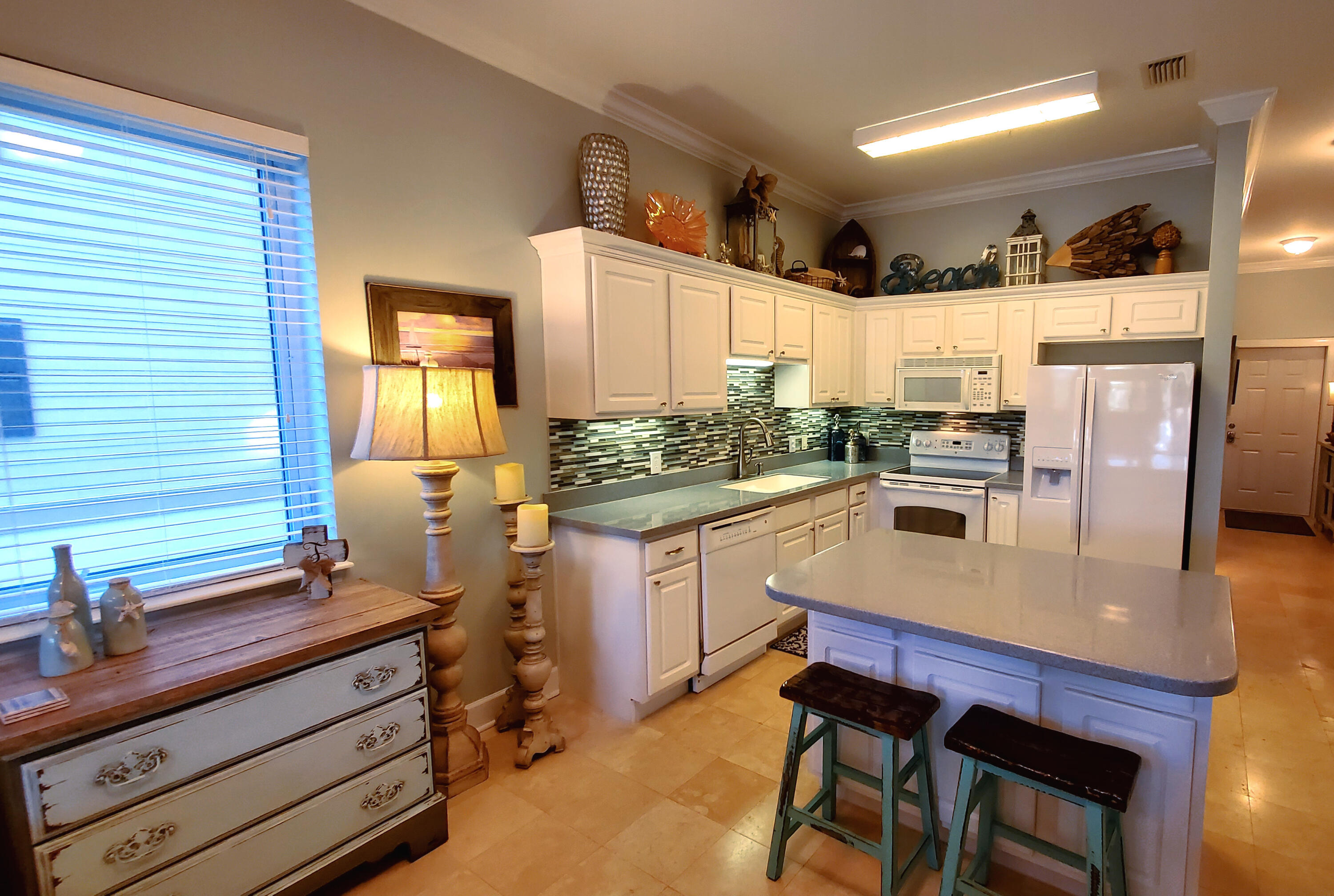 Wonderfully upgraded 2nd floor end unit condo with additional windows, crown molding in main area, mosaic tile backsplash in kitchen. Travertine and luxury wood vinyl flooring throughout. This unit has been meticulously cared for and enjoyed only as a 2nd home, but is being offered fully furnished, pleasantly decorated, equipped and ready to make a perfect rental, second home or residence. The current owners love the easy access by just one flight of stairs or elevator. Seagrove Highlands is gated and tucked away from all the 30A hoopla but is conveniently close to beach access at the end of the street, bike path, neighboring restaurants, shops, entertainment, and everything the 30A lifestyle has to offer. Come and see. 2206 Seagrove Highlands is waiting for you to come and enjoy.