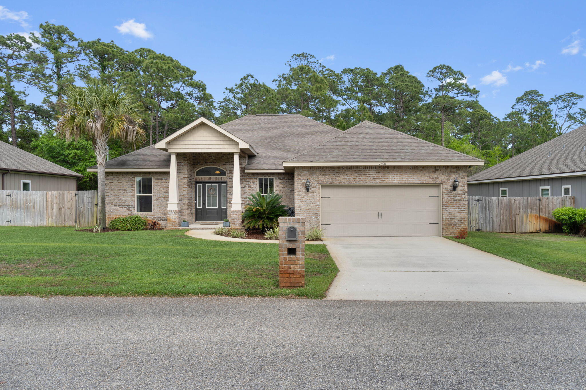 Welcome home to this stunning 4 bedroom/2 bath all brick home with a split floor plan and all the updated finishes you're looking for in your new home! Enjoy living the coastal lifestyle near beautiful Navarre Beach with a boat launch at the end of your street and a dock in your neighborhood of Magnolia Harbor! This 2,133sqft home welcomes you in with the tasteful and well maintained landscaping and inside where you'll find 9-12' ceilings, a spacious great room, a formal dining room (currently a play room), as well an additional eat in kitchen area. You'll enjoy hard surface Allen Roth flooring throughout the common areas with tile in the kitchen, bathrooms, and interior laundry room. The well appointed kitchen features granite counters, stainless appliances, drop down pendants over the hop up bar, and undermount lighting. You'll love the great room with it's stunning custom built in fireplace area with shiplap (current fireplace insert will convey). The owner's suite is a fantastic space with a trey ceiling and a relaxing en suite with double granite vanities, a walk in shower, separate soaking tub, and a huge walk in closet! The other three bedrooms are located on the other side of the house and have ample closet space with another full bathroom located between two of them. Outside enjoy the privacy with no homes behind you and a covered back patio and extended concrete pad to enjoy within the fully fenced in backyard (complete with a sprinkler system!). Appreciate this central Navarre location close to Gulf Breeze and Fort Walton Beach with easy access to schools, shopping, and more! (No flood insurance required)
