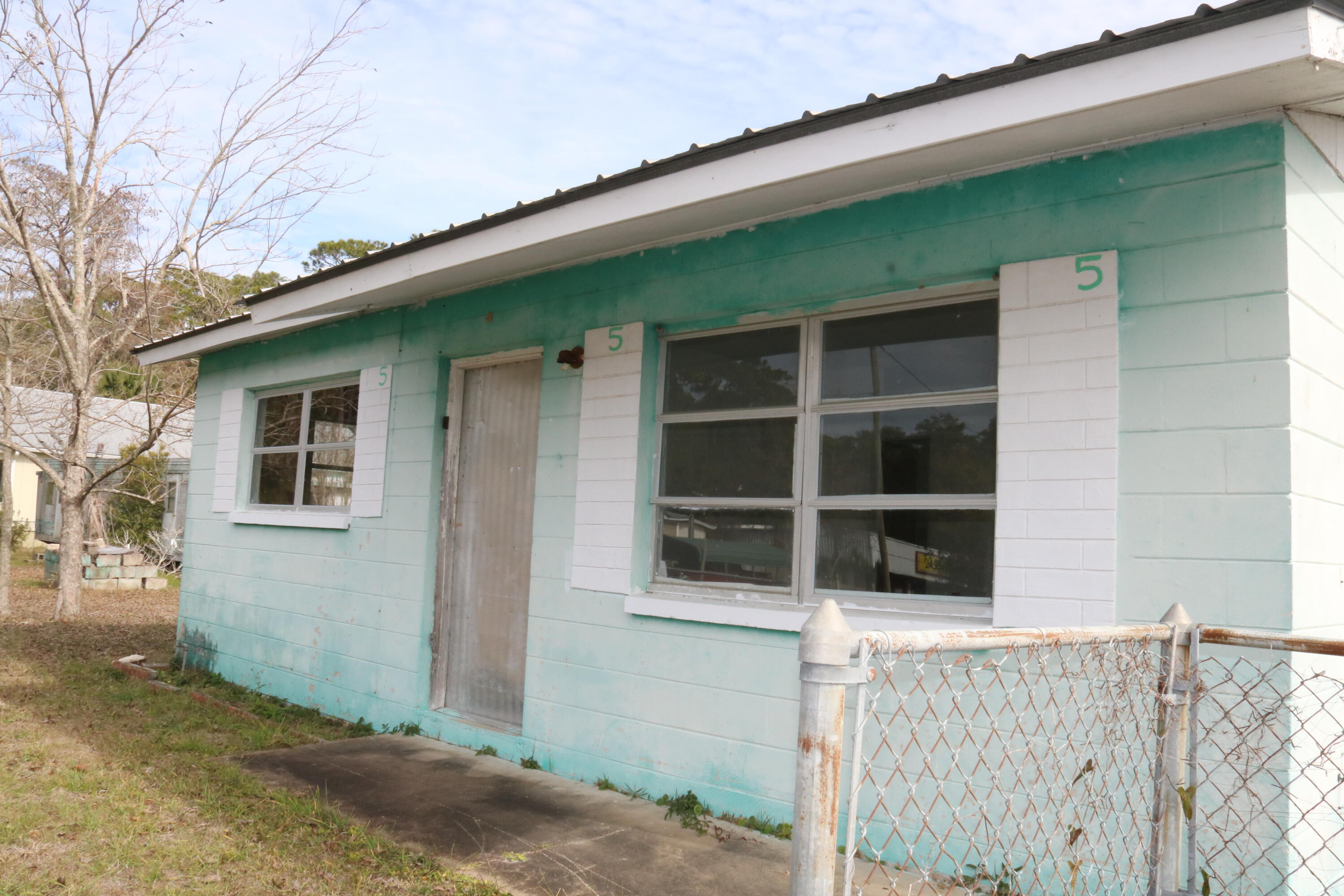 Fantastic Opportunity to own a little piece of Apalachicola History. The 2 bedroom/1 bathroom beach cottage sits on a .26 acre parcel with an additional mobile home on the back of the lot, Mixed use opportunities! The 2/1 home has a metal roof and both dwellings would be great to fix up and use as  a summer getaways or vacation rentals. Situated on a large corner lot with pecan and pear trees and bay views. What are you waiting for! A property such as this one has so much offer and do not come on the market very often. The possibilities are endless! Call today