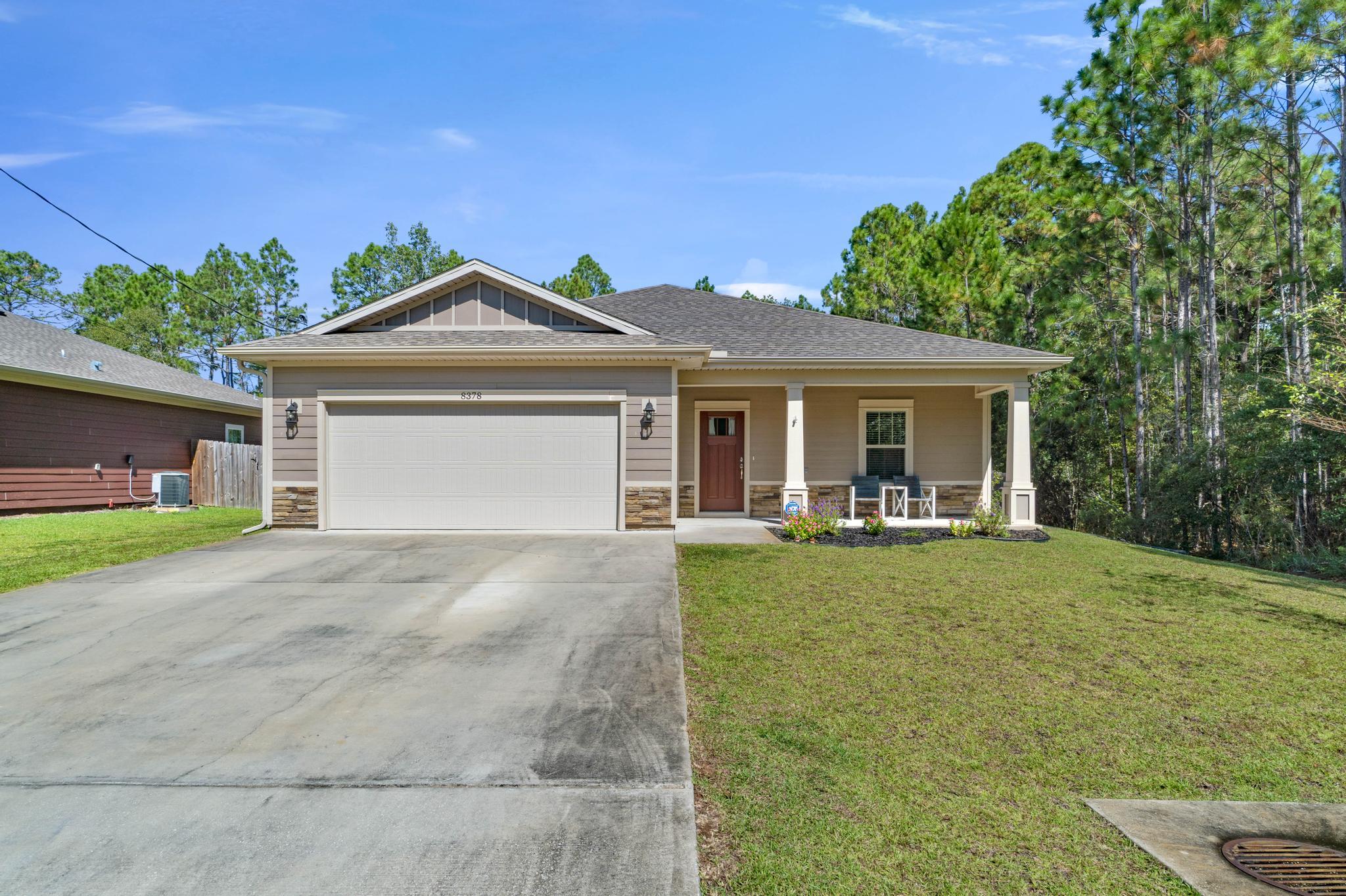 Like new with no HOA! Welcome home to this stunning craftsman style Ramsey & Walker built home that's only 4 years young featuring 3 bedrooms and 2 baths. Located at the end of a quiet dead end street and a quick drive to Hurlburt Field, you'll love the privacy of this property while also being only minutes to Navarre's beautiful beaches. Pull up the driveway in front of the two car garage and walk to the front door where you'll find an adorable covered front porch inviting you in. Through the threshold a long open entryway will greet you with a trey ceiling accented with crown molding and a front entry closet. The open floor plan awaits you with a large living space adorned with hard surface flooring open to the stunning kitchen. Stocked with all the updated features you're looking for, you'll love the custom tall cabinets with tasteful hardware, the granite counters, the large island with plenty of room for seating, the stainless steel appliances, drop down pendant lighting, and the spacious pantry. Off the kitchen is the dining room featuring another trey ceiling, and the back door leads outside to the large fenced in backyard complete with a sprinkler system, playground, seamless gutters, and a property line that extends far past the fence! Back inside the split floor plan features bedrooms on either side of transom windows which provides a nice high end custom touch. The master bedroom is a fantastic and spacious retreat with a trey ceiling and crown molding and a master bathroom with gorgeous granite double vanities, a tiled shower with soaking tub, and a massive walk in closet! The other two bedrooms on the other side of the home are nice sized with ample closet space, and a beautiful bathroom with matching finishes between them along with a hall closet. The interior laundry room has the same tiled floor as the bathrooms and leads to the garage. Bring your electric car! In the garage features a plug in for your electric car as well as pull down attic space for additional storage. You're minutes from Navarre Beach, Navarre High School, the YMCA, Navarre Youth Sports Association, as well as dog parks and walking paths. Don't delay in making this your perfect retreat for a primary residence or investment property.