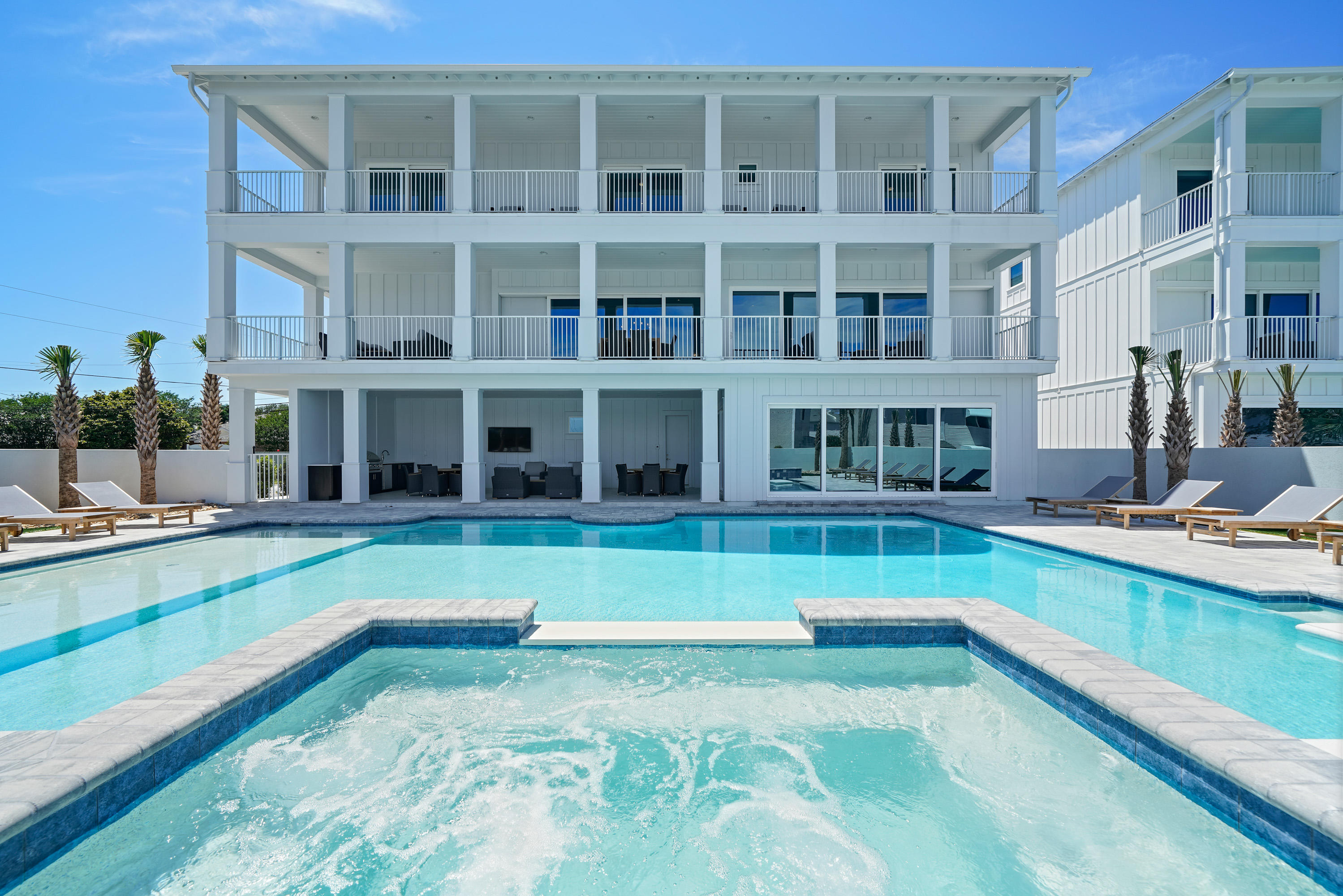 Introducing ''Castawaves,'' a newly constructed 6,333-square-foot 8-bedroom designer showpiece with stunning coastal interiors, state-of-the-art amenities, and a resort-style pool. This luxury beach home is already a significant income producer with $265K in projected annual rental income. No HOA dues. Open-air comforts include a custom-designed LED-lit pool with sundeck, elevated spa, summer kitchen, covered outdoor dining, four terraces, and rooftop deck, offering sensational sunset vistas. Lifelike synthetic turf provides zero maintenance and year-round beautification. This home has all the essentials for entertaining - ample parking, large gathering spaces, seamless indoor-outdoor flow, and a lavish chef's kitchen - plus a private movie theatre and fully equipped game room. A sparkling white exterior with metal clad roof echo the home's fresh approach to modern coastal design. Clean lines and crisp whites are sophisticated, classic, and calming. The kitchen is supplied with top-of-the-line appliances including a 6-burner Wolf range and under-counter wine fridge. The extra-large kitchen island with seating for eight is highly functional and on-trend. Bedrooms include private baths with designer finishes. "Castawaves" is just a short walk or bike ride to the pristine beaches of the Emerald Coast, eateries, and shops. Stylish furnishings convey in sale. The adjoining home 212 Driftwood Rd is also for sale.