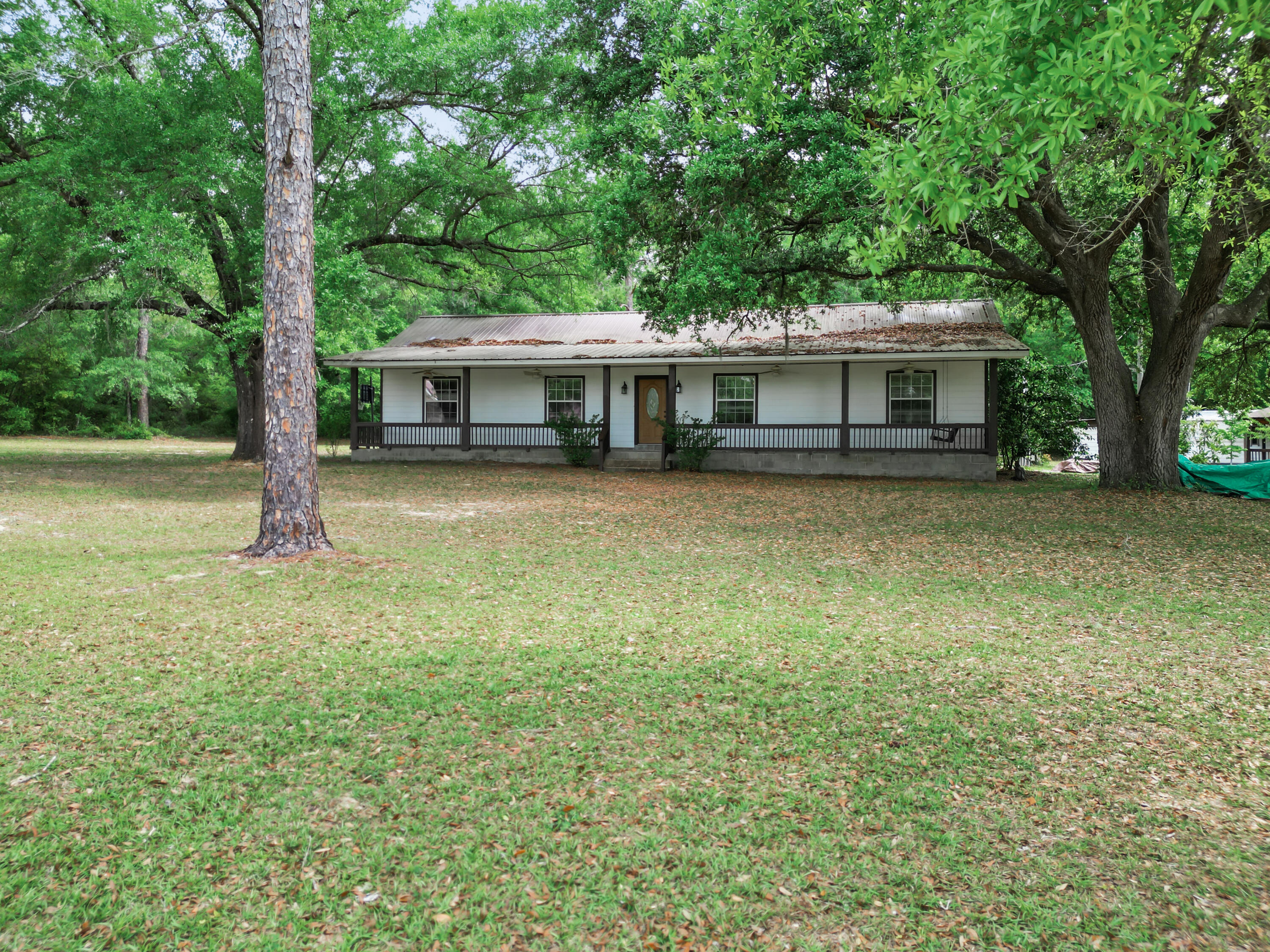 CURRENTLY UNDER CONTRACT, SELLER WILL CONSIDER BACKUP OFFERS

Welcome to 15766 NE Bob Sanders Road in Hosford, FL, set on 6 acres in Liberty County.

This 3-bedroom, 2-bath home built in 2010 offers 1,736 sq. ft. with front and back porches for enjoying the outdoor setting. 

The property includes a stocked pond, outdoor cooking shed, spacious workshop, and a carport with RV hookup. The usable acreage provides room for gardening and recreation. 

Located minutes from the Apalachicola National Forest, it is approximately 45 minutes from Tallahassee International Airport, about an hour to downtown Tallahassee, and just over an hour to the beaches of St. George Island. 

Schedule your private showing to see the home and land in person.