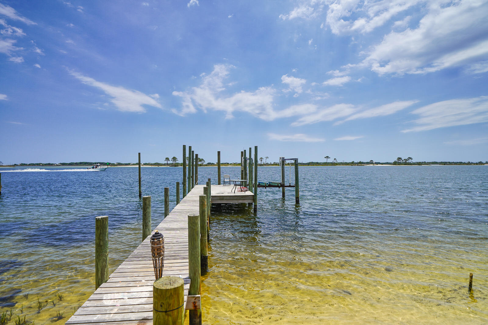 SHORT TERM RENTALS ALLOWED!! 
 Beautiful multi-faceted waterfront property with an array of possibilities! Three parcels stretch from Highway 98 to the Sound. The northmost parcel on Miracle Strip is a commercial zoned vacant .29-acre lot. The other two parcels feature 3 Florida cottages: a 2-bedroom 2-bath rental cottage on .13 acres in the middle, and on the south end, a .32-acre parcel with a 2-bedroom 1-bath rental cottage and a waterfront house with 2 bedrooms and 2 baths. The waterfront house fronts 68 feet on the Sound, with a dock and a boat lift.  Listed as 3 separate MLS listings as well:  898338, 901426 and
898111.  Buyer to verify all dimensions.