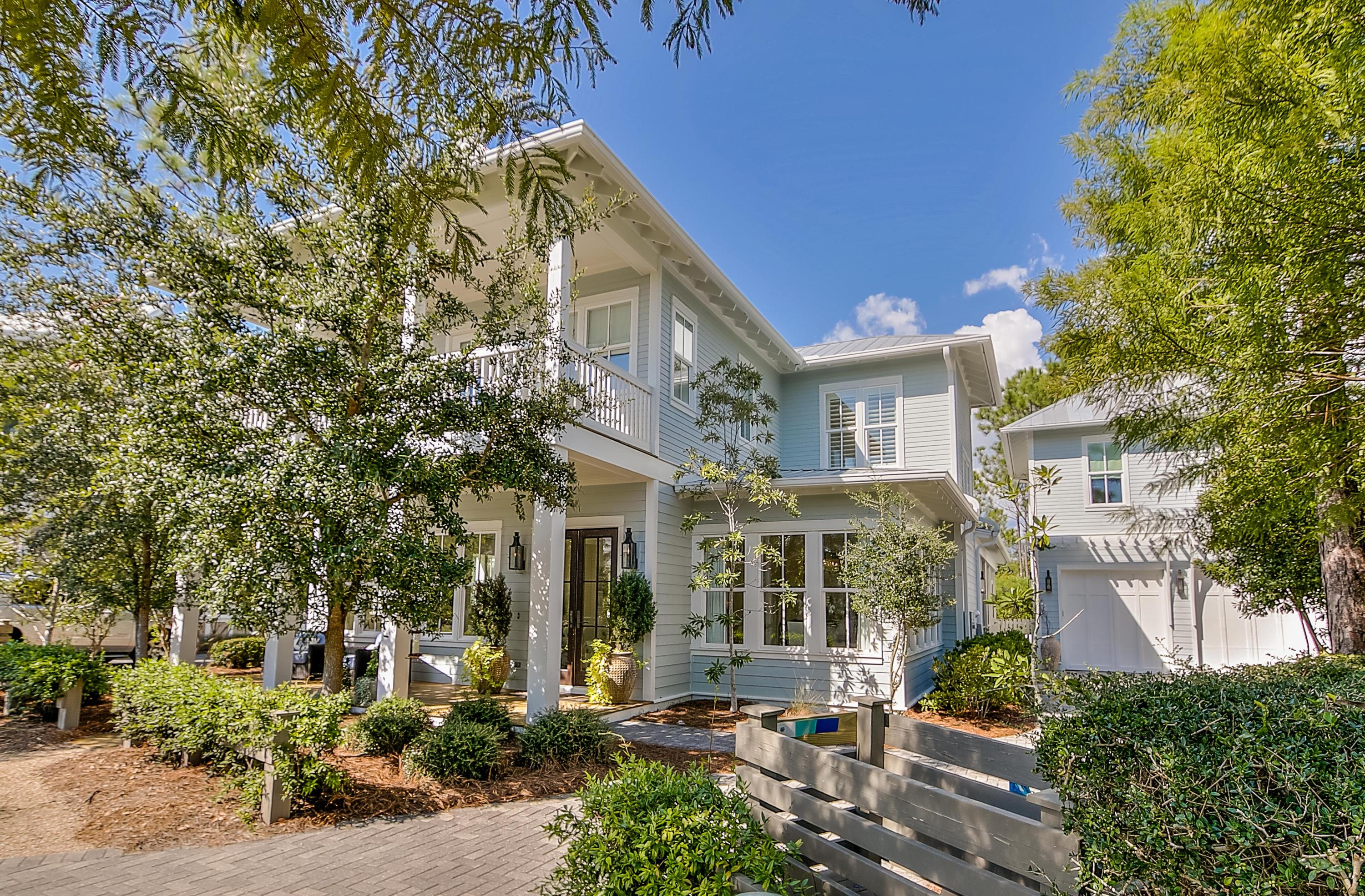 Stunning & elegant home in popular Phase IV of WaterColor. This incredible home with outstanding designer selected interiors is perfect for full time living. The main house features 4 bedrooms, large private office, master suite with expanded walk in closet, built in side grilling porch with gas & charcoal options, mud room with custom cabinetry, custom wine cellar, and a massive L-shaped screened in porch with sitting area and dining area. The carriage house features a spacious bedroom/living area, private bath, & kitchenette. The oversized 2-car garage is a real bonus as is the driveway that can accommodate up to 4 additional vehicles.
The lot that this home is built on is one of the larger lots in Phase IV and backs up to a nature preserve area and is bordered on one side by a community path.  Built by Romair Construction, this floorpan offers a wonderful open concept living.  A home of this caliber with a 2 car garage and extra parking space is truly rare in Watercolor.