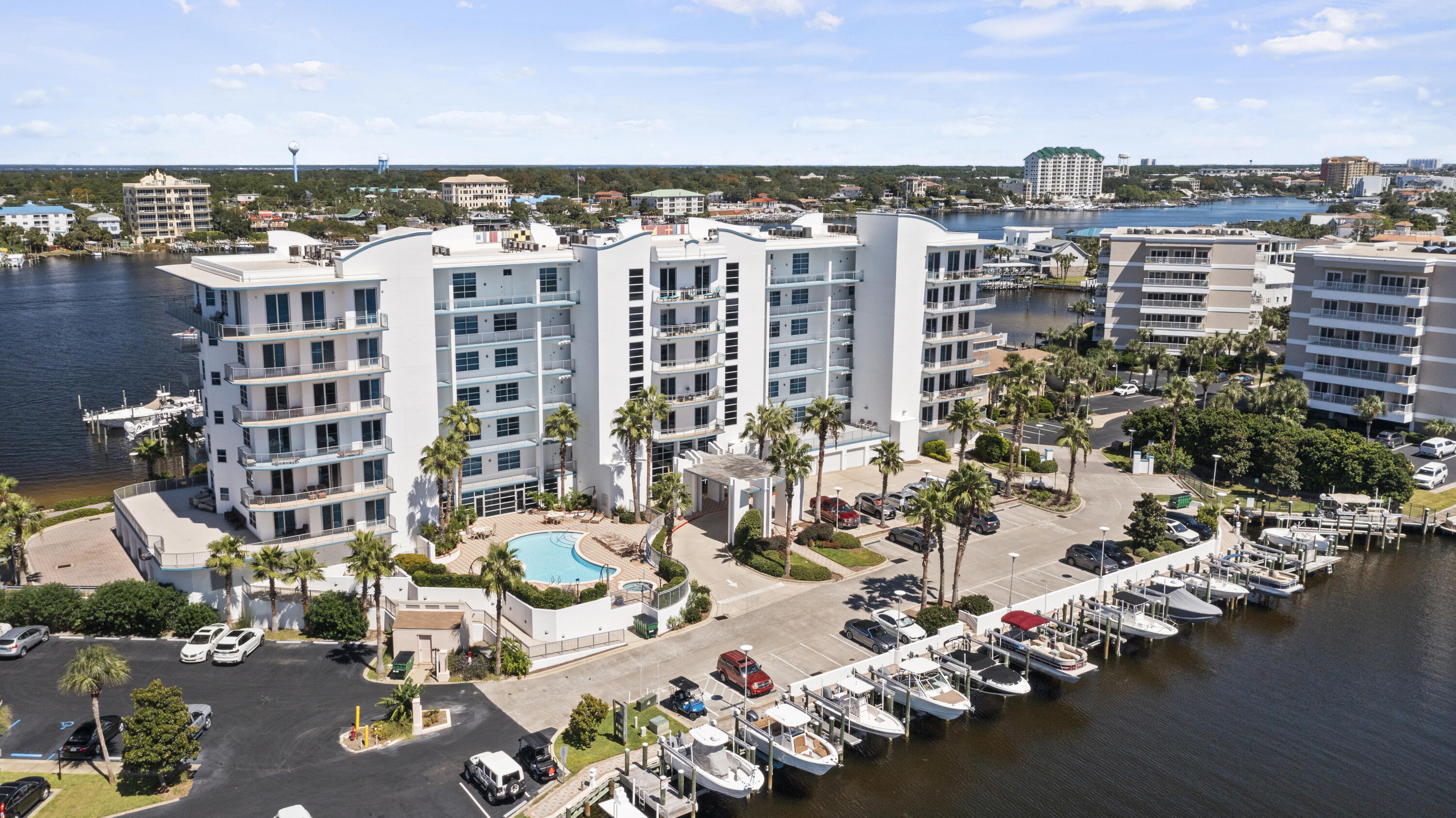 This BEAUTIFUL second floor unit is highlighted by 10-foot ceilings, an open floor plan, a wall of glass sliders, & crown molding in the living area. Tile flooring flows through the entry, living, kitchen, & bathrooms. Granite countertops, pantry, custom tile backsplash, stainless steel appliances & a large breakfast bar in the kitchen. The harbor front master bedroom features a spacious walk-in closet, his and her vanities and walk-in shower. The 2nd bedroom overlooks the pool and canal. Harbor Lights boasts EXCELLENT community amenities, with a common area, paddle board storage, owner's only beach
access, conference room, gated access, and a beautiful pool. You'll also have access to a fitness center with separate men's and women's locker rooms, a dry sauna, and a steam room. This unit conveys with Storage #35.